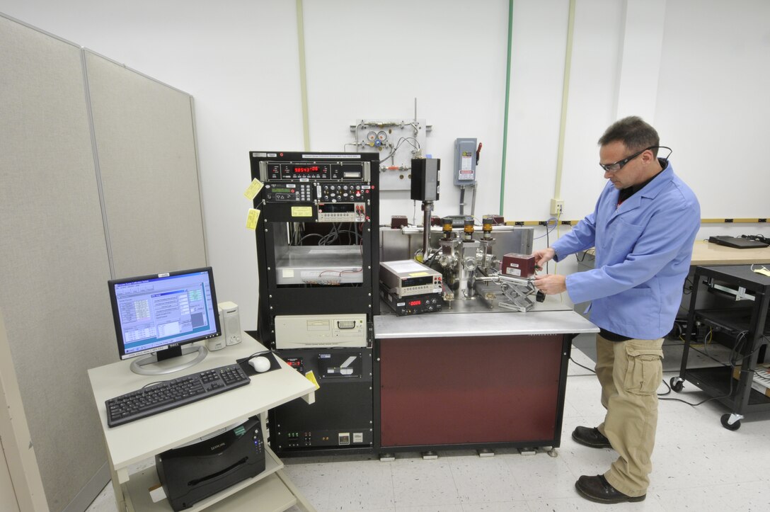 AEDC PMEL Instrument Technician Barry Benson adjusts a capacitance diaphragm gauge using an automated vacuum gauge calibration system. (Photo by Rick Goodfriend)