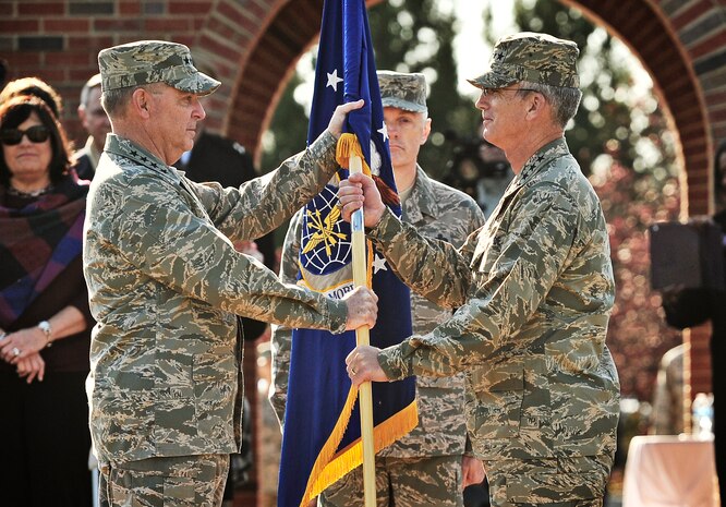 Gen. Paul J. Selva accepts the Air Mobility Command guidon from Gen. Mark A. Welsh III, Chief of staff of the Air Force, during the change of command ceremony at Scott Air Force Base, Ill., Nov. 30, 2012. Selva was previously assigned as the assistant to the Chairman of the Joint Chiefs of Staff in Washington D.C. The outgoing commander, Gen. Raymond E. Johns Jr., served 35 years in the Air Force, commanding more than 130,000 Airmen as well as reaching 4,500 flight hours in various aircraft. (U.S. Air Force photo/Staff Sgt. Ryan Crane)