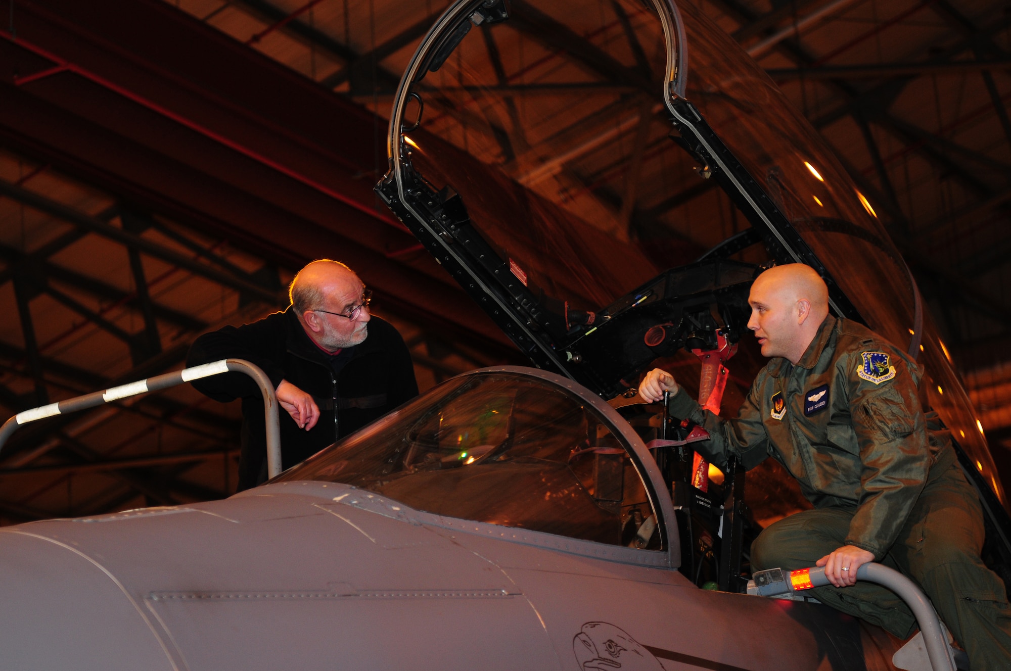 ROYAL AIR FORCE LAKENHEATH, England – Colin Burvill (left), a native of Maidstone, England receives an F-15E Strike Eagle capabilities briefing from 1st Lt. Ryan Claussen, 492nd Fighter Squadron pilot, during a tour Nov. 29, 2012. Spotter Watch provides the spotters an avenue to report suspicious activity outside the gates of the base. (U.S. Air Force photo by Airman 1st Class Cory D. Payne)