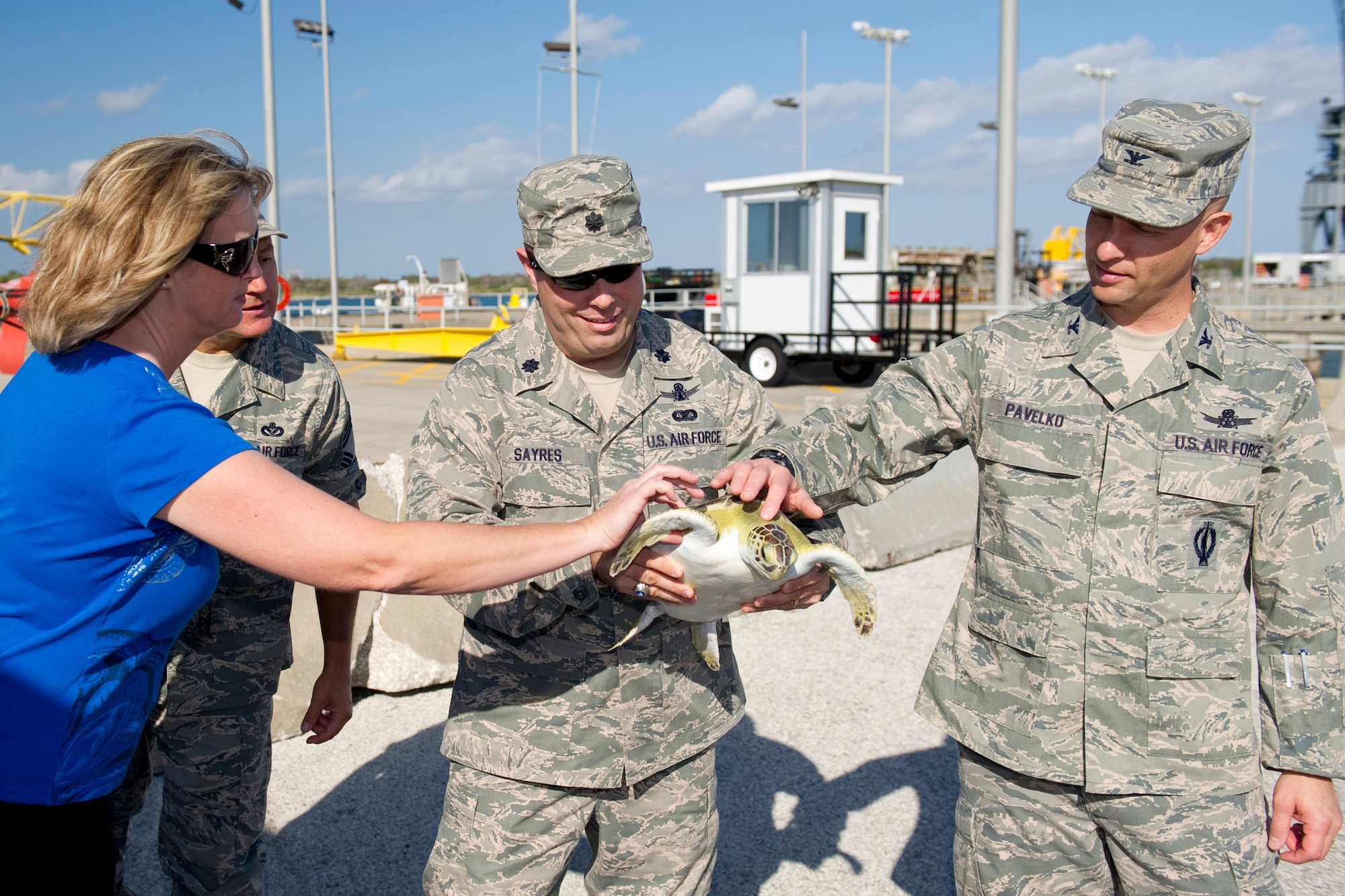 Col. Robert Pavelko, 45th Space Wing vice commander, and Lt. Col. Ed Marshall, 45th Mission Support Group deputy commander, release rehabilitated sea turtles while Chief Master Sgt. Carroll Holcombe, 45th Mission Support Group superintendent, watches along the beach at Cape Canaveral Air Force Station.
