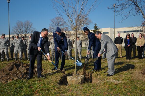 During a ceremony Nov. 21 at Wright-Patterson, a cherry tree is planted as part of the Operation 1000 Cherry Trees initiative. Planting the tree are (L-R): Consul General Kuninori Matsuda, consulate general of Japan in Detroit; Air Force Life Cycle Management Center Commander Gen. C.D. Moore II; 88th Air Base Wing Commander Col. Cassie Barlow; and Dayton businessman Alex Hara.  (photo by Niki Jahns) 