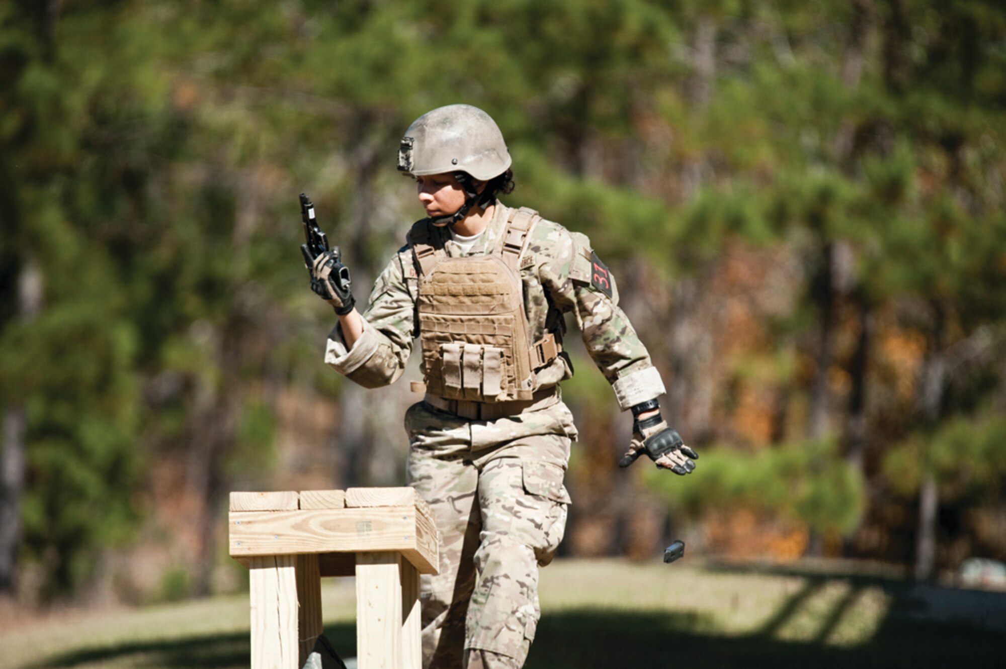 Staff Sgt. Monica Gonzalez, 620th Ground Combat Training Squadron nuclear security instructor, releases a spent clip from her M-9 pistol during an event in the 2012 International Sniper Competition at Fort Benning, Ga., which took place Nov. 2 through 5. (Courtsey photo)