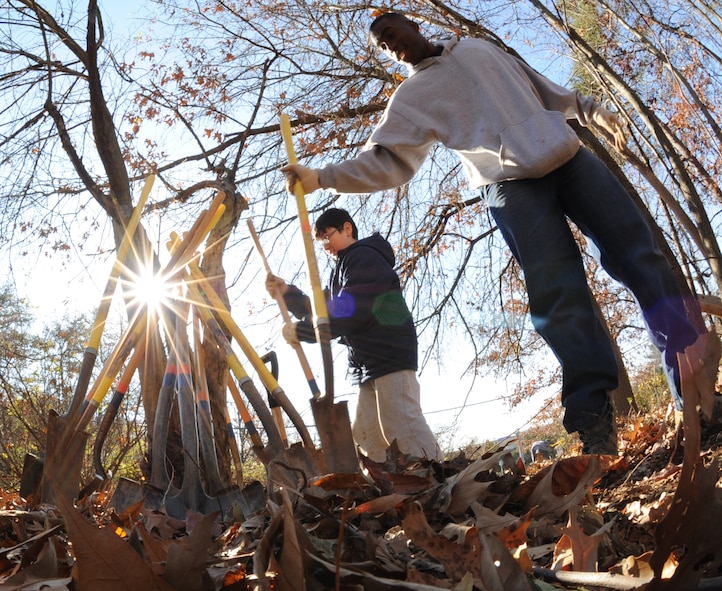Members of the U.S. Air Force Honor Guard Drill Team and students at Belvedere Elementary School plant a tree at Belvedere Park near the school in Falls Church, Va., Nov. 26, 2012.  The Drill Team has a close relationship with Belvedere Elementary and its students. (U.S. Air Force photo/Staff Sgt. Torey Griffith)