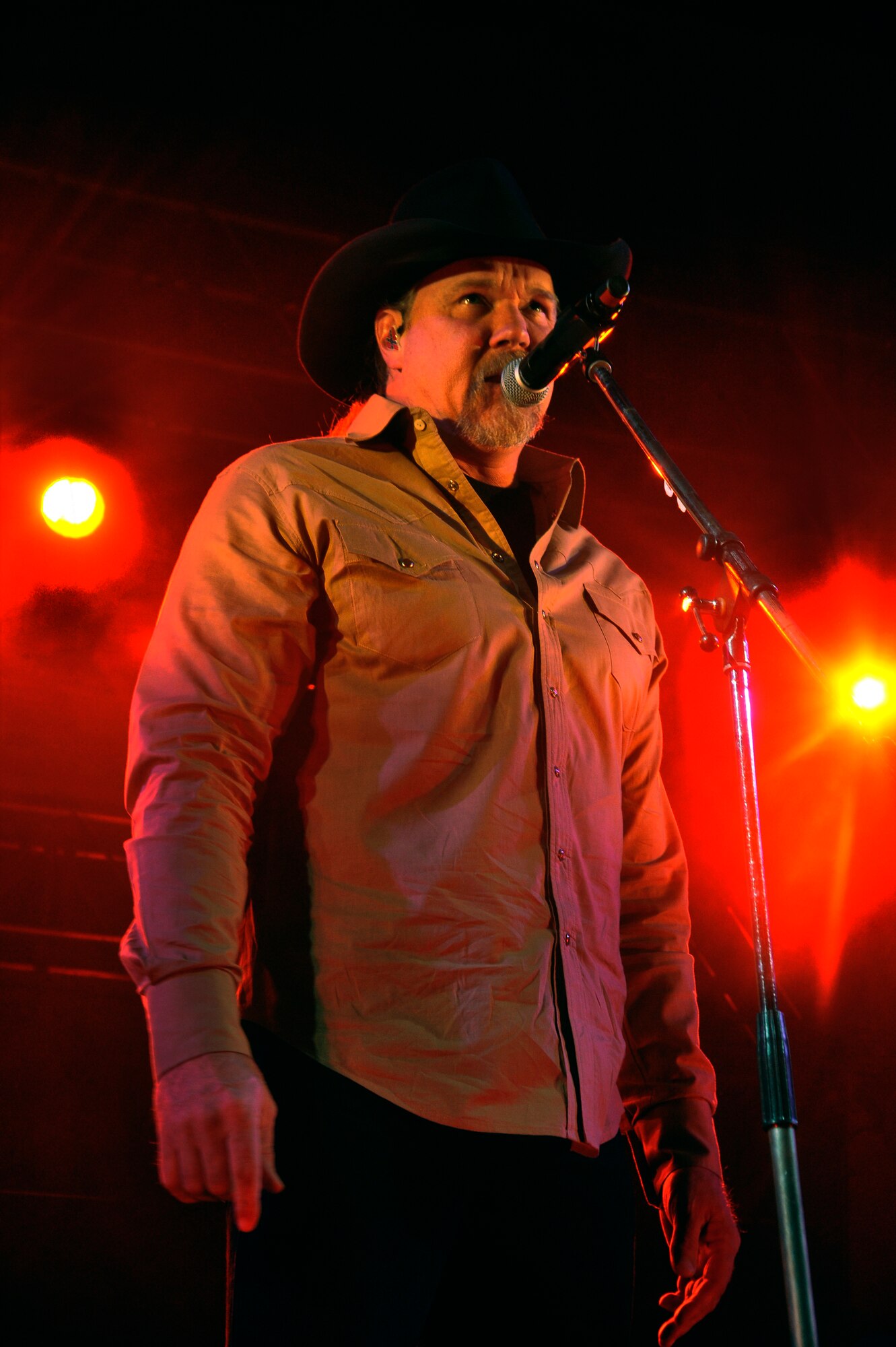 Trace Adkins, country music artist, performs for more than 1,000 service members and dependents during his USO tour at Misawa Air Base, Japan, Nov. 28, 2012. The USO is a world-wide organization that seeks to contribute to the morale and personal welfare of U.S. military personnel and their families. (U.S. Air Force photo by Airman 1st Class Zachary Kee)