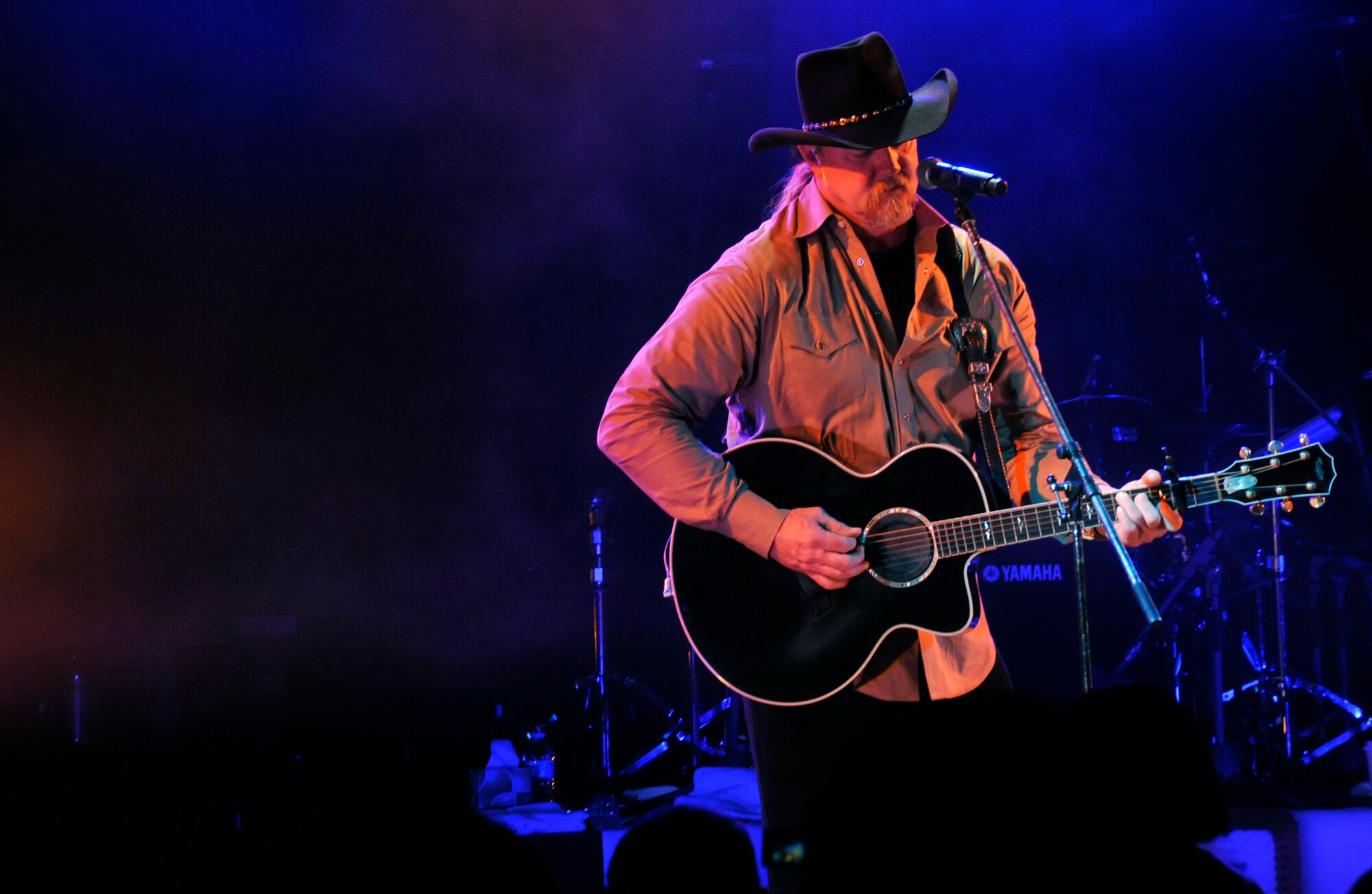 Trace Adkins, country music artist, sings and plays gutiar for more than 1,000 service members and dependents at Misawa Air Base, Japan, Nov. 28, 2012. For Adkins, this is his first time touring in Japan and his seventh USO tour in the past 11 years. (U.S. Air Force photo by Airman 1st Class Zachary Kee)