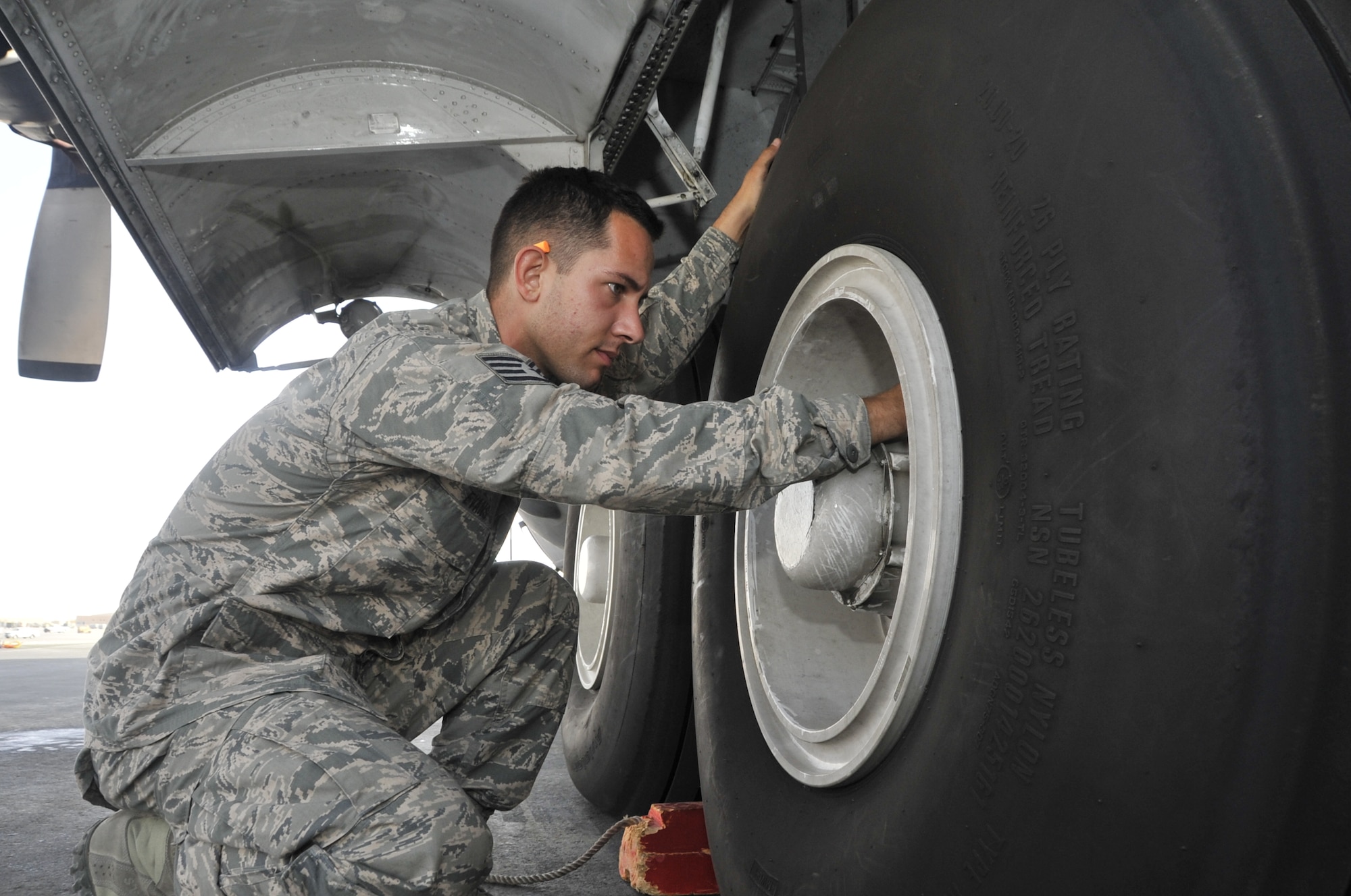Staff Sgt. Joshua Evans, 746th Expeditionary Aircraft Maintenance Unit crew chief, checks for overall tire serviceability of a C-130 Hercules during a routine pre-flight inspection Nov. 27. He also conducts a complete inspection of the landing gears and inspects miscellaneous hardware for any leakage within the hydraulics systems. Evans is a member of the 746th EAMU crew chiefs deployed from Yakota Air Base, Japan. The team arrived to the 379th Air Expeditionary Wing in September and was responsible for the onward movement of more than 415 tons of cargo. Evans is a native of Tampa, Fla. (U.S. Air Force photo/Senior Airman Bryan Swink)