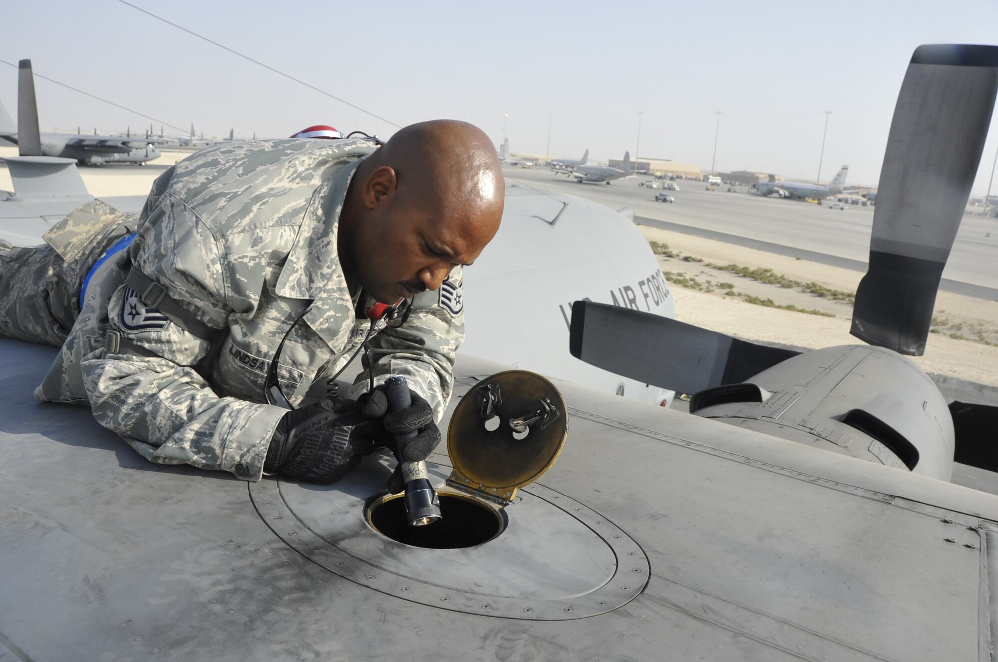 Staff Sgt. Javier Lindsay, 746th Expeditionary Aircraft Maintenance Unit crew chief, conducts an inspection on the number three engine’s dry bay of a C-130 Hercules Nov. 27. Lindsay is looking for leaks or abnormalities within the bay before its cleared to fly. These inspections are conducted before and after any C-130 mission. The 746th EAMU is a maintenance unit assigned to the 379th Air Expeditionary Wing. The C-130 crew chiefs are deployed from Yakota Air Base, Japan. Lindsay is a native of Hartford, Conn. (U.S. Air Force photo/Senior Airman Bryan Swink)