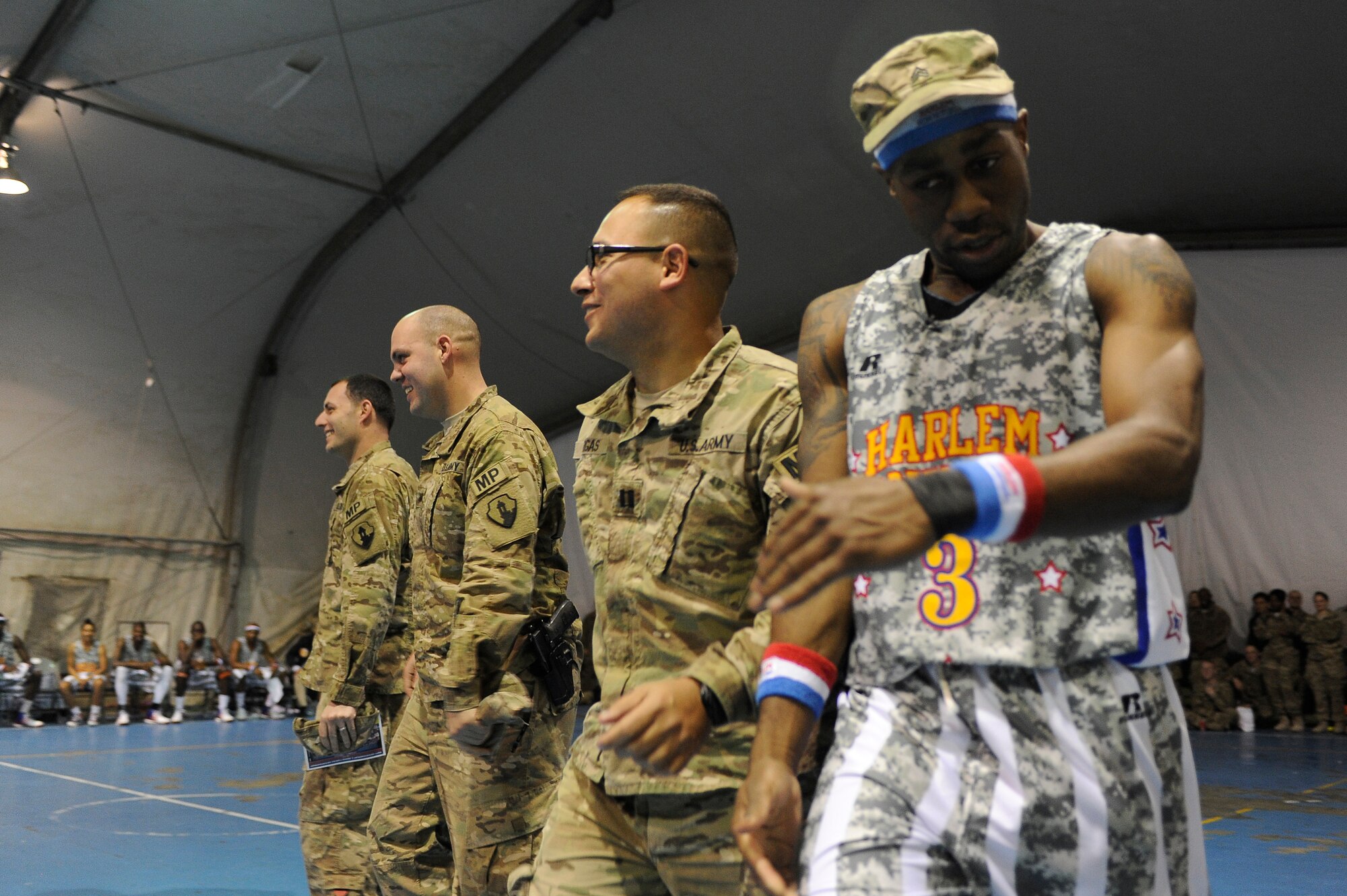 “Firefly” Fisher attempts to use the U.S. Army Military Police as camouflage to “ambush” a fellow Globetrotter with water. The visit was the first for the Globetrotters to Afghanistan, making it the 121st country and territory the team visited. (U.S. Air Force photo/ Master Sgt. Jun Kim)