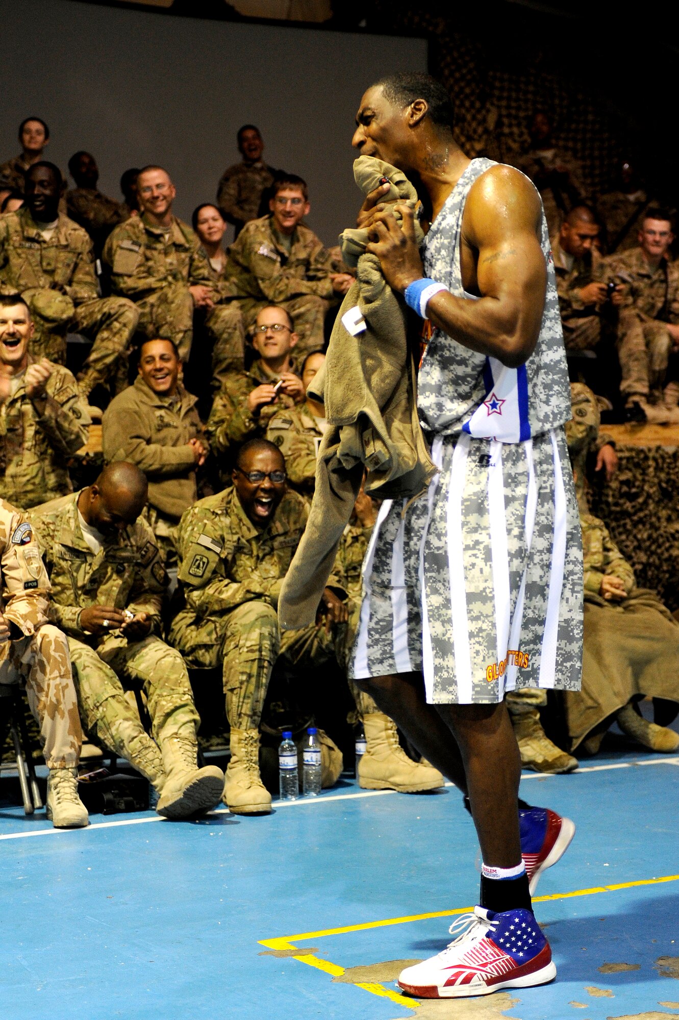 “Hi-Lite” borrows a U.S. Airmen’s jacket to towel off after being doused with water by a fellow Globetrotter at Bagram Airfield, Afghanistan, Nov. 28, 2012. The visit was the first for the Globetrotters to Afghanistan, making it the 121st country and territory the team visited. (U.S. Air Force photo/ Master Sgt. Jun Kim)