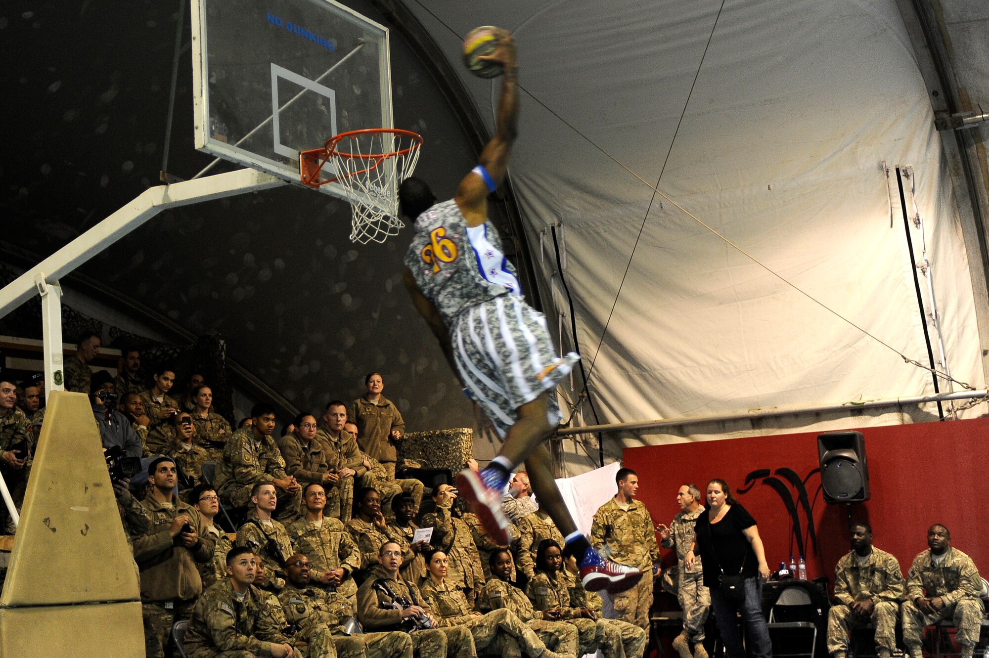 “Hi-Lite” Bruton lives up to his nickname with his high-flying slam dunk at Bagram Airfield, Afghanistan, Nov. 28, 2012. The visit was the first for the Globetrotters to Afghanistan, making it the 121st country and territory the team visited. (U.S. Air Force photo/ Master Sgt. Jun Kim)