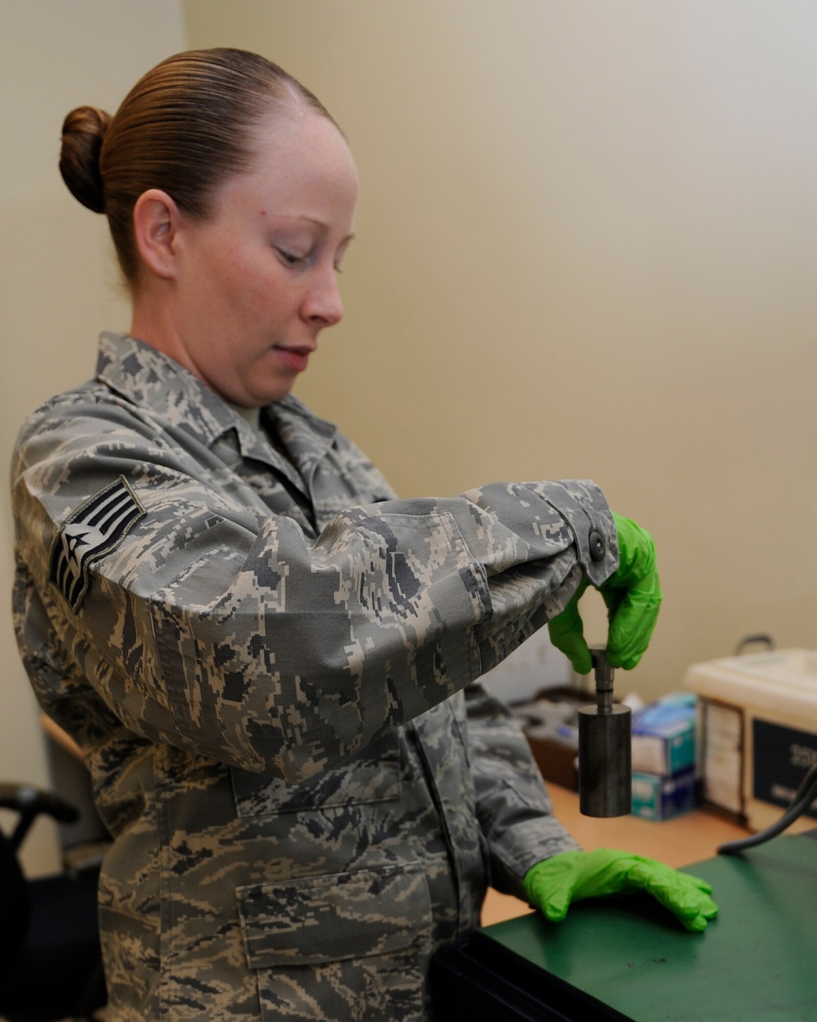 Staff Sgt. Morgan Quinn, 8th Maintenance Squadron nondestructive inspection assistance section chief calibrates a magnetic chip detector with a weight on Kunsan Air Base, Republic of Korea, Nov. 21, 2012. The magnetic chip detector allows NDI to test the aircraft engine for wears. (U.S. Air Force photo by Senior Airman Marcus Morris/Released)