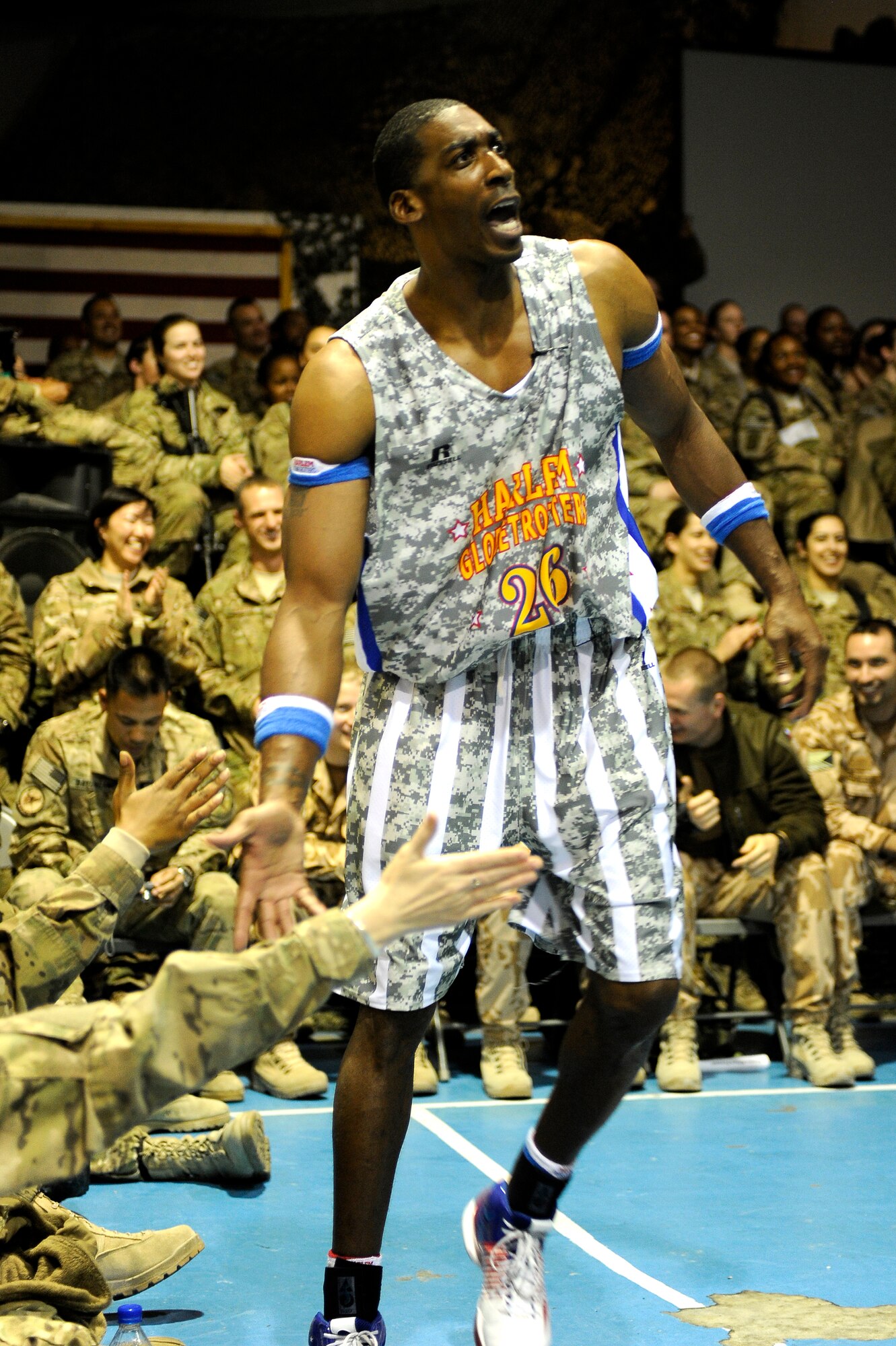 “Hi-Lite” Bruton works the crowd of Bagram service members after making a high-flying slam dunk at Bagram Airfield, Afghanistan, Nov. 28, 2012.  The visit was the first for the Globetrotters to Afghanistan, making it the 121st country and territory the team visited. (U.S. Air Force photo/ Master Sgt. Jun Kim)