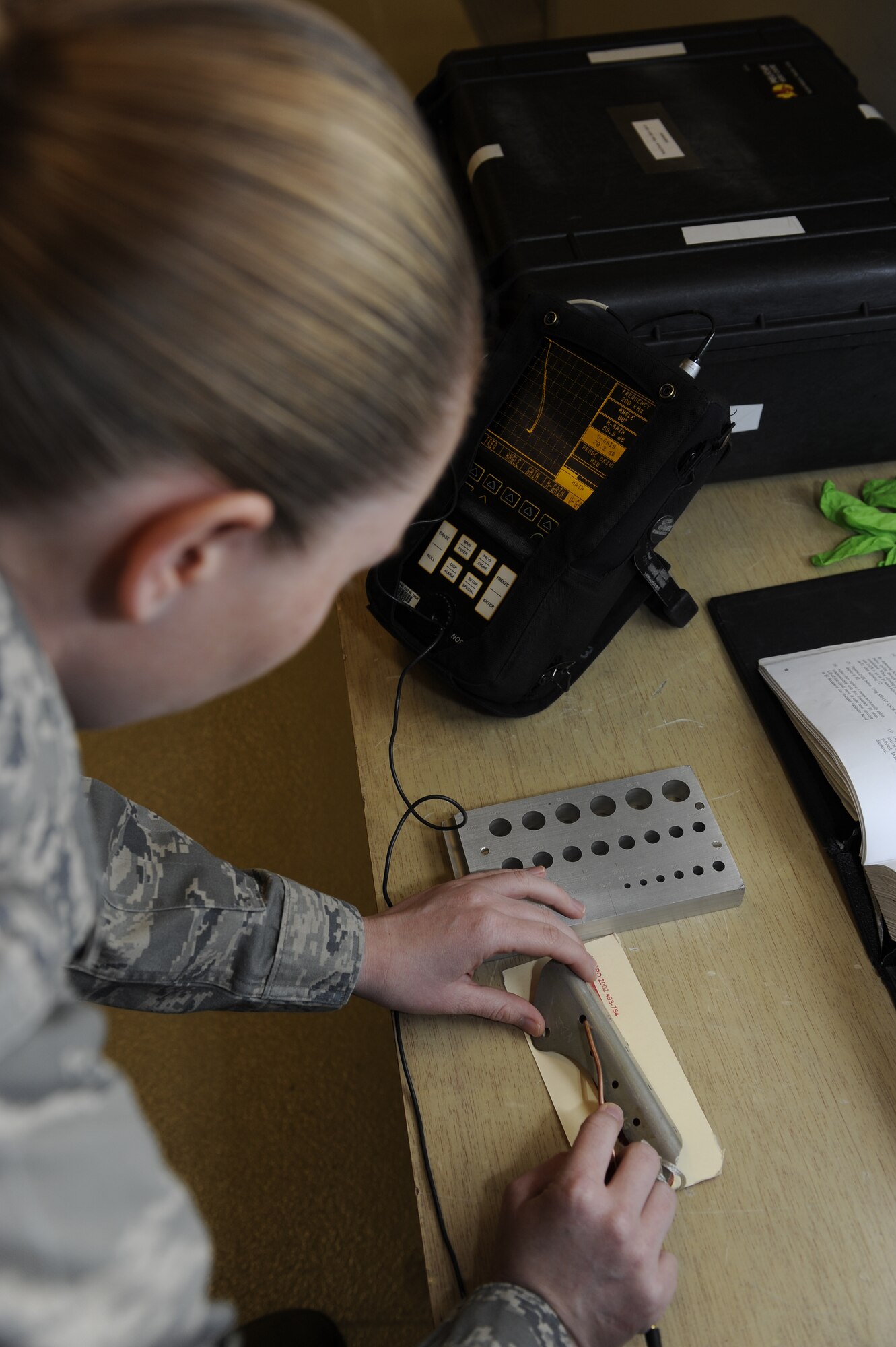 Staff Sgt. Morgan Quinn, 8th Maintenance Squadron nondestructive inspection assistance section chief performs an eddy current inspection on a wing strake bracket on Kunsan Air Base, Republic of Korea, Nov. 21, 2012. If the bracket, used to help attach the wing to the fuselage of the aircraft, is cracked it could cause the wing to separate from the aircraft possibly in flight. (U.S. Air Force photo by Senior Airman Marcus Morris/Released)