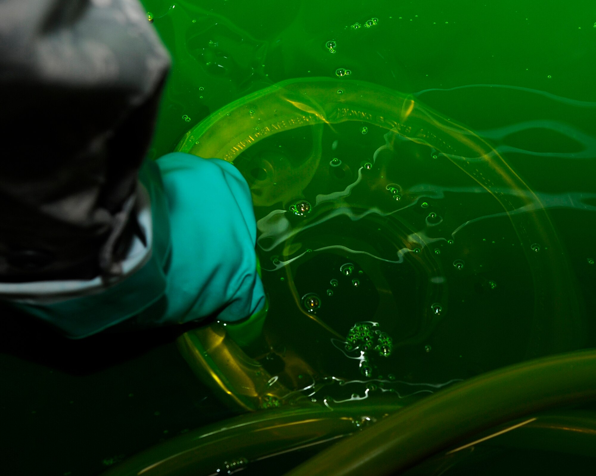 Senior Airman Matthew Barnes, 8th Maintenance Squadron nondestructive inspection  technician performs a penetrant inspection on nose landing gear wheels on Kunsan Air Base, Republic of Korea, Nov. 21, 2012. The penetrate seeps into any discontinuity in the wheel which will appear fluorescent green under black light. (U.S. Air Force photo by Senior Airman Marcus Morris/Released)