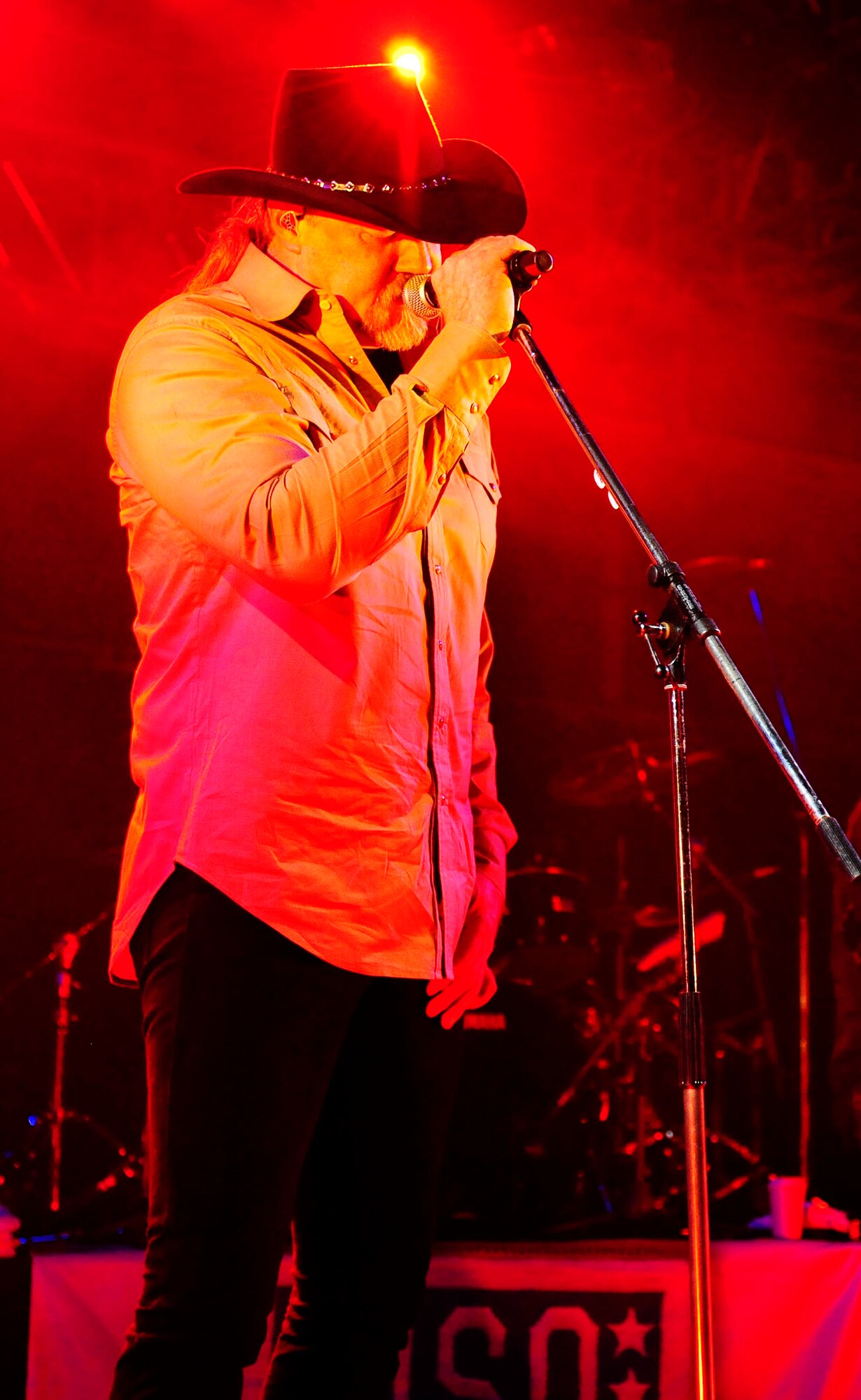 Trace Adkins, country music artist, sings at a USO-hosted concert in an aircraft hangar at Misawa Air Base, Japan Nov. 28, 2012 for more than 1,000 service members and dependents. This is the singer’s first time touring in Japan and his seventh USO tour in the past 11 years. (U.S. Air Force photo by Staff Sgt. Jess Lockoski) 