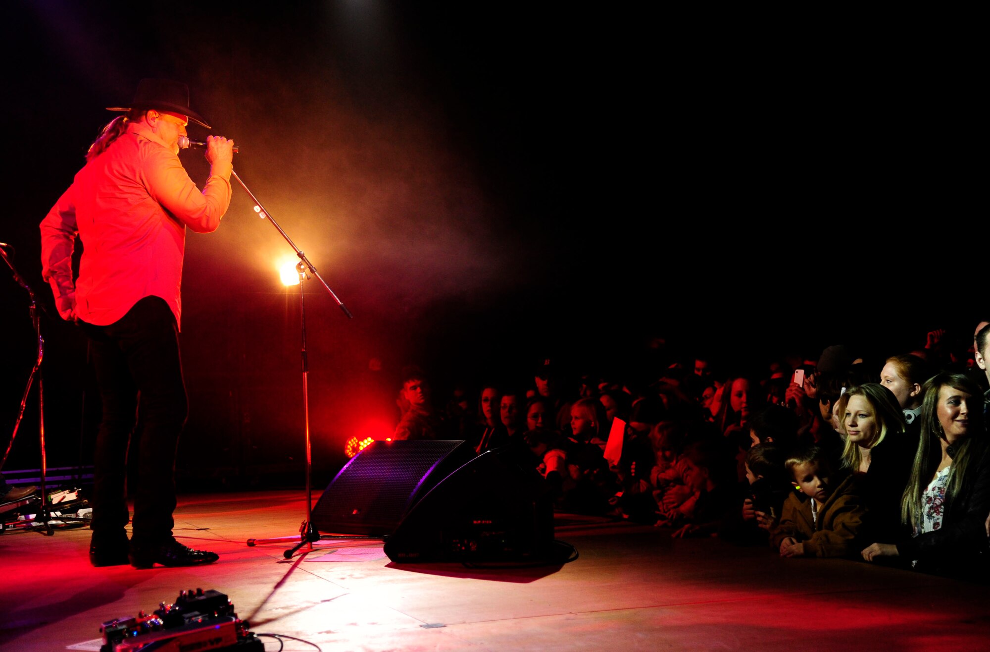 Trace Adkins, country music artist, sings at a USO-hosted concert in an aircraft hangar at Misawa Air Base, Japan Nov. 28, 2012 for more than 1,000 service members and dependents. USO entertainers help fulfill the USO’s missions of boosting the morale for servicemembers stationed overseas, deployed and in the United States. (U.S. Air Force photo by Staff Sgt. Jess Lockoski) 
