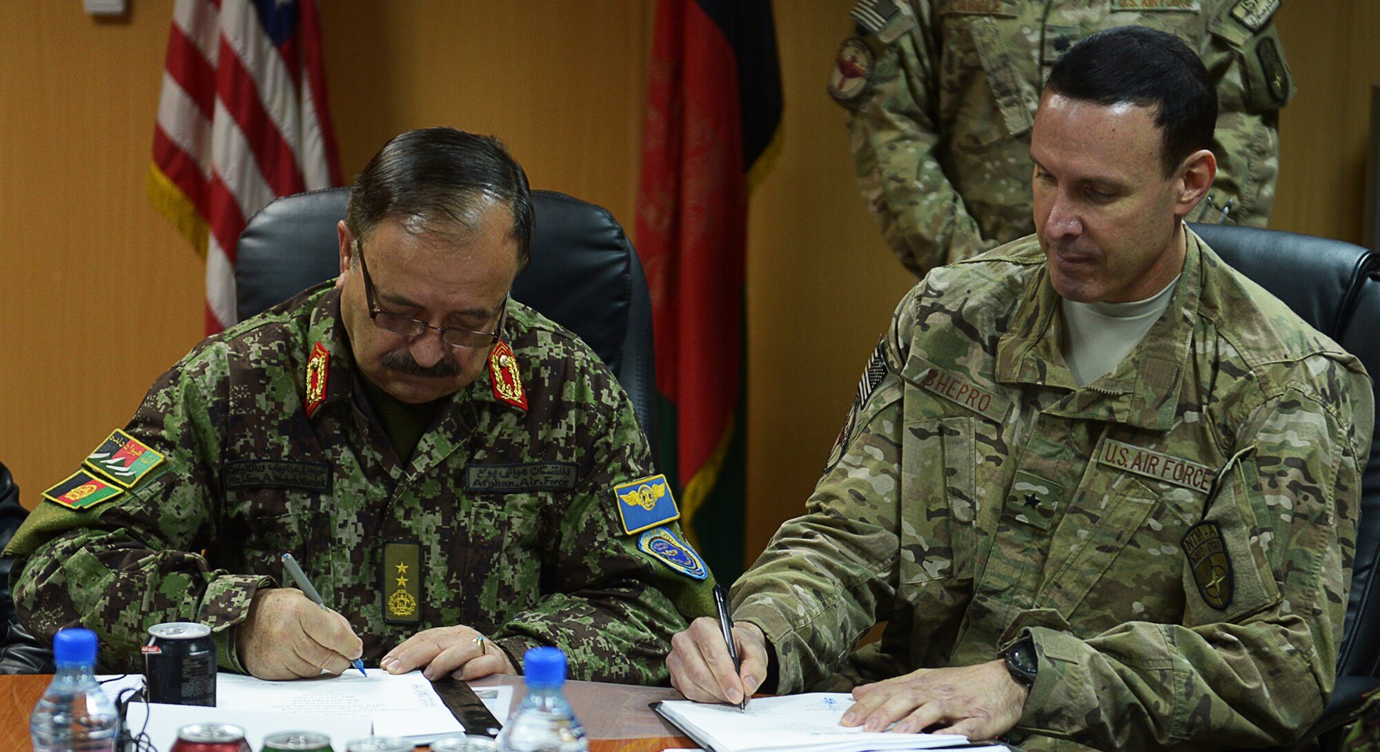Maj. Gen. Abdul Wahab Wardak, commander of the Afghan Air Force, and Brig. Gen. Steven Shepro, commander of NATO Air Training Command-Afghanistan, sign the first ever combined strategy into effect Nov. 28, 2012 in NATC-A headquarters at the Kabul, Afghanistan, International Airport. The 54-page document committed both commands to action on jointly developed vision, goals and milestone timelines into 2013 and beyond in support of Afghan AF development.
