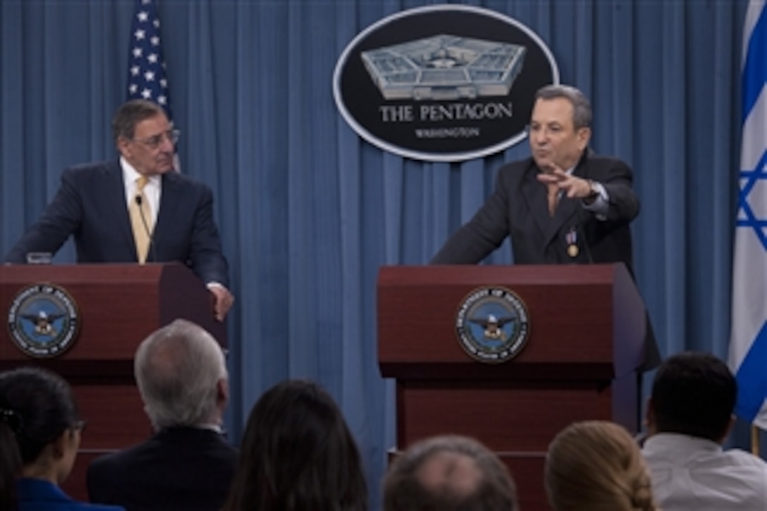 Secretary of Defense Leon E. Panetta, left, listens to Israeli Minister of Defense Ehud Barak during a joint press conference in the Pentagon on Nov. 29, 2012.  Panetta and Barack met earlier to meet to discuss national and regional security items of interest to both nations.  Panetta awarded Barack the Department of Defense Medal for Distinguished Public Service before taking questions from the press.  