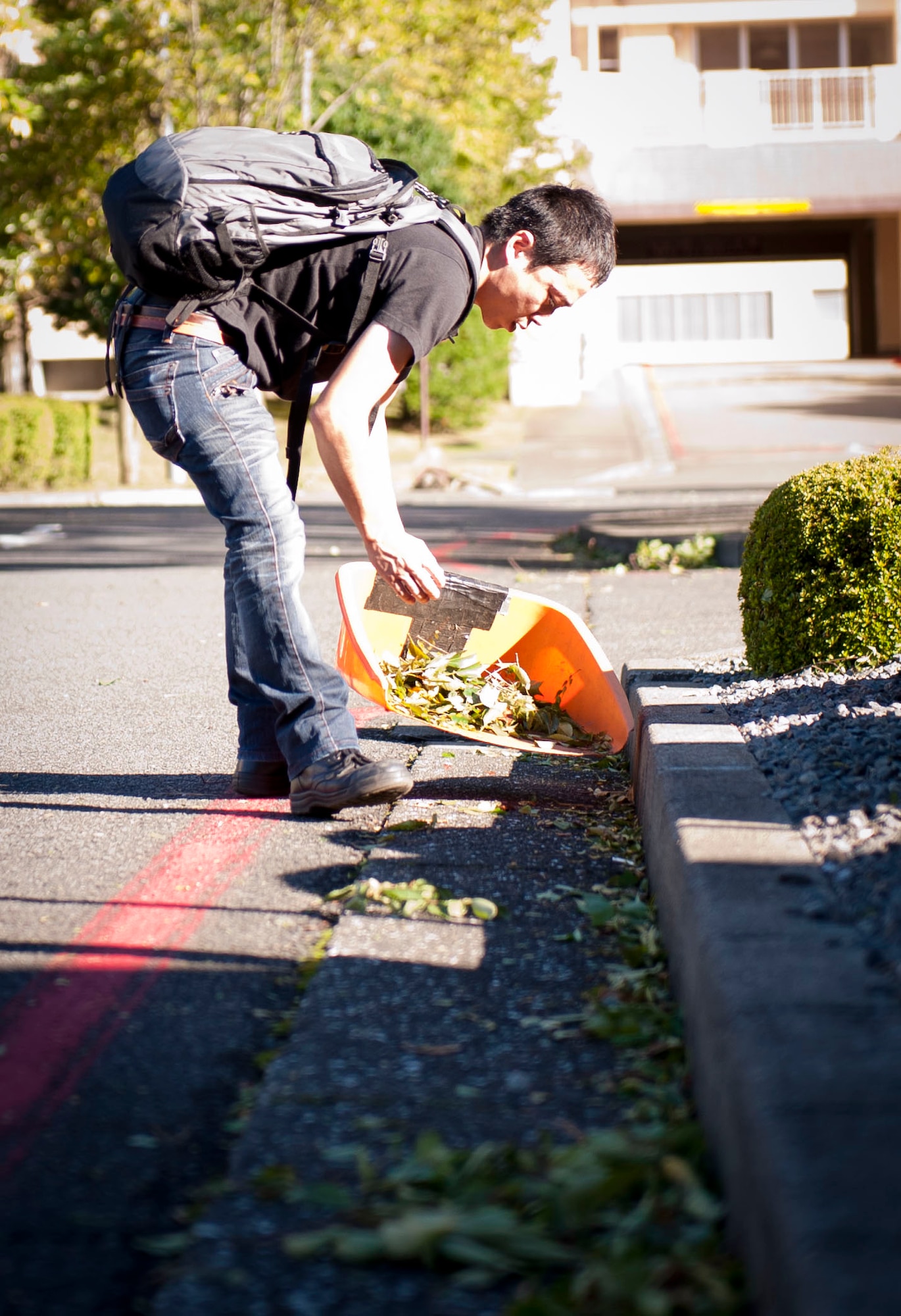 YOKOTA AIR BASE, Japan -- Yuji Kikuta, Yokota Enlisted Club employee, cleans up debris in the Enlisted Club parking lot left from Typhoon Jelawat that passed through Yokota Air Base, Japan on Oct. 1, 2012. A typhoon is a Pacific-region storm with a defined surface circulation and wind speeds between 74 and148 mph. (U.S. Air Force photo by Airman 1st Class Krystal M. Garrett) 