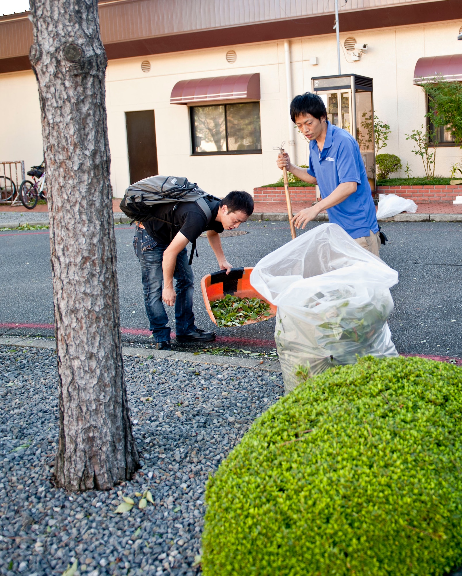 YOKOTA AIR BASE, Japan -- Personnel from the Enlisted Club clean up debris left from Typhoon Jelawat at Yokota Air Base, Japan, Oct.1, 2012.  On average, Yokota is affected by two typhoons each year. (U.S. Air Force photo by Airman 1st Class Krystal M. Garrett) 