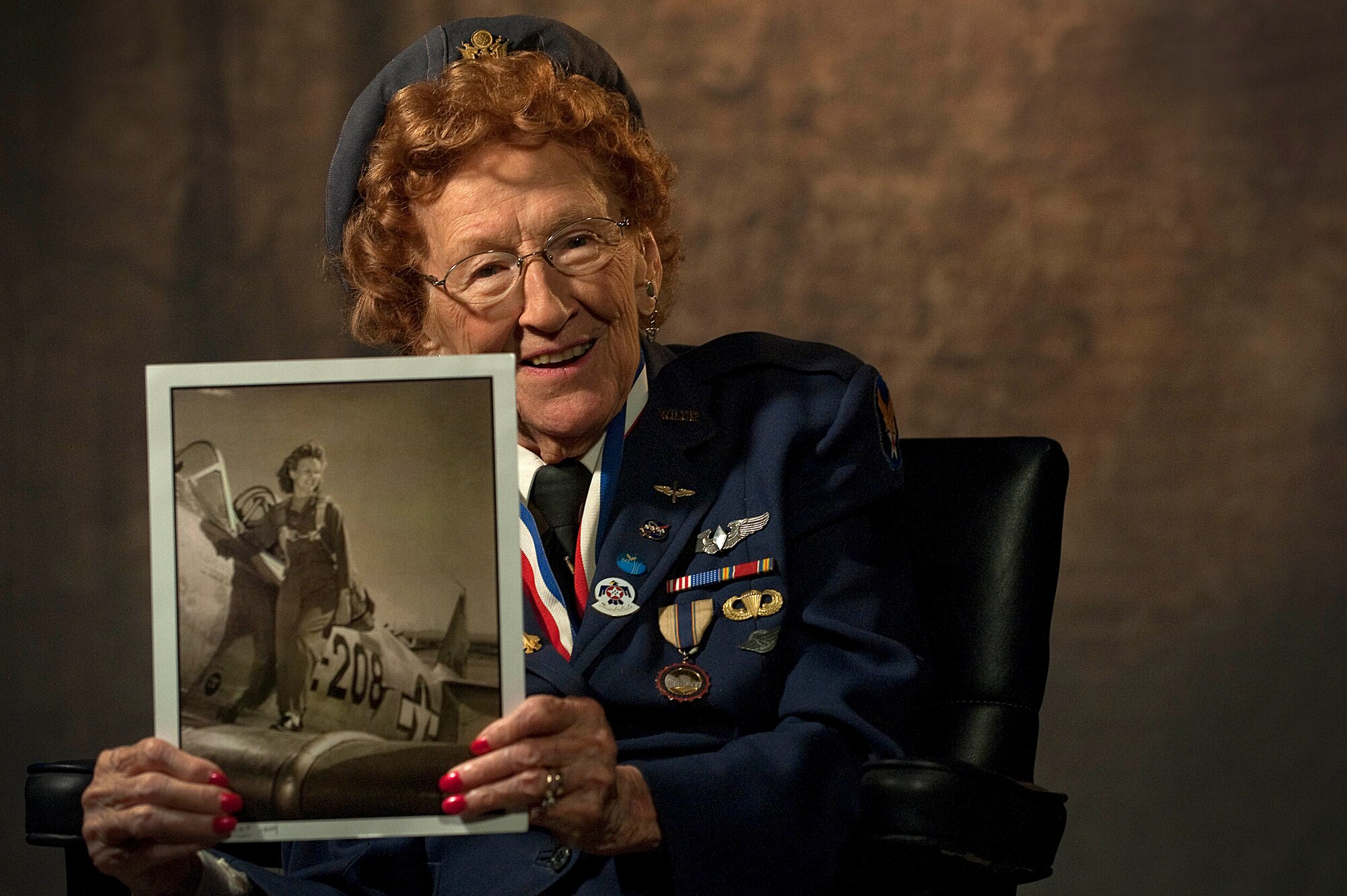 Betty Wall Strohfus, a WWII Women Airforce Service Pilot, holds a picture of herself when she was a WASP pilot, Sept. 27,2012, at Nellis Air Force Base, Nev. Strohfus was stationed at Las Vegas Army Air Field from 1943-44, and was one of 1,074 women who became certified WASP pilots during WWII. Las Vegas Army Air Field later was re-designated as Nellis AFB. The female pilots of the WASP freed up male pilots for combat services and duties during the WWII era. (U.S. Air Force photo by Staff Sgt. Christopher Hubenthal)
