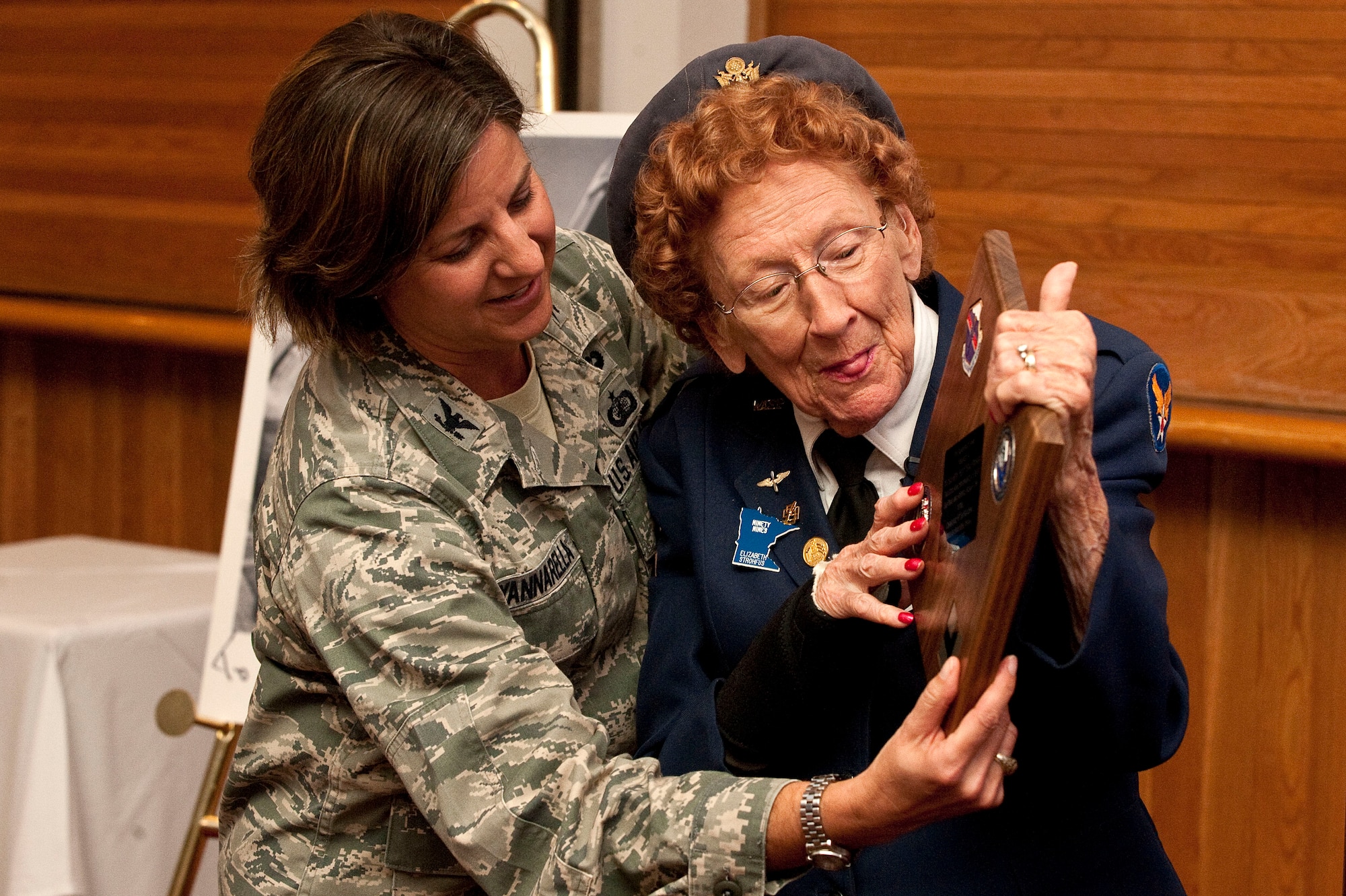 Col. Carol Yannarella, 99th Air Base Wing vice commander, presents the Diamondback Award to Betty Wall Strohfus, a WWII Women Airforce Service Pilot, during a distinguished visit Sept. 27, 2012, at Nellis Air Force Base, Nev. The Diamondback Award is awarded to Airmen who help keep the spirit of innovation alive. (U.S. Air Force photo by Staff Sgt. Christopher Hubenthal)