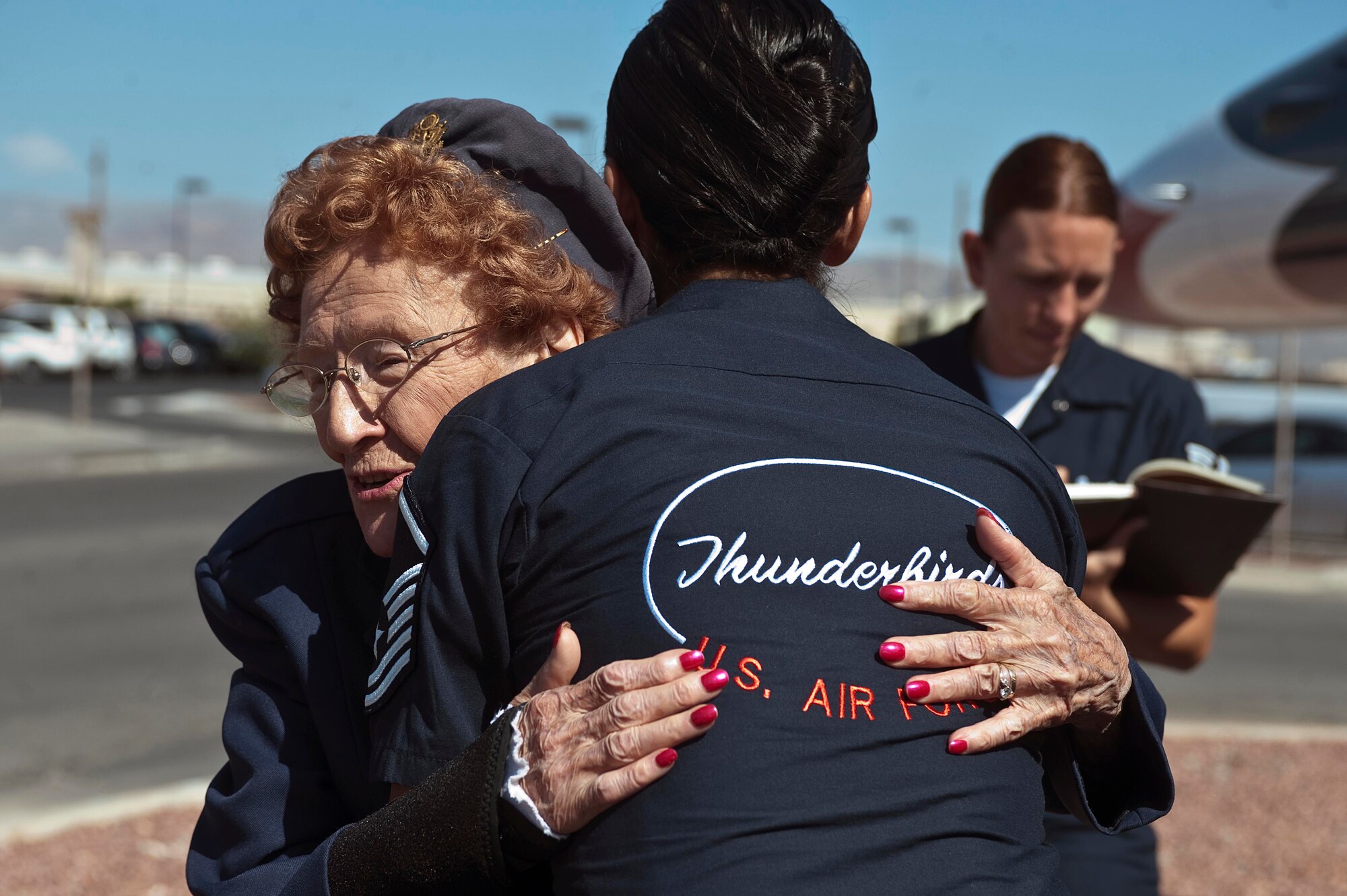 Betty Wall Strohfus, a WWII Women Airforce Service Pilot, hugs Master Sgt. Gina Creel, U.S. Air Force Aerial Demonstration Squadron "Thunderbirds," commander support staff noncomissioned officer in charge , during a distinguished visit Sept. 27, 2012, at Nellis Air Force Base, Nev. Strohfus was stationed at Las Vegas Army Air Field from 1943-44, and was one of 1,074 women who became certified WASP pilots during WWII. Las Vegas Army Air Field later was re-designated as Nellis AFB. (U.S. Air Force photo by Staff Sgt. Christopher Hubenthal)