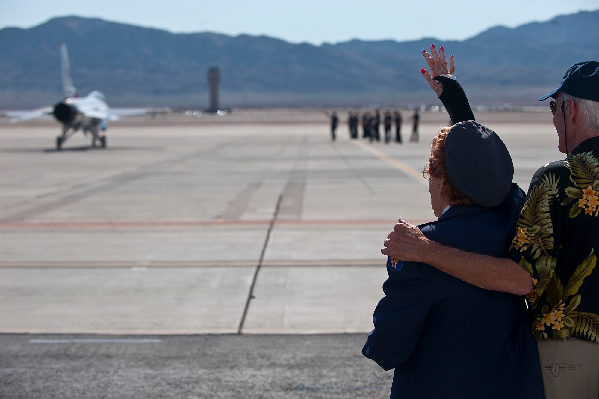 Betty Wall Strohfus, a WWII Women Airforce Service Pilot, and Mike Roberts, Strohfus' son, wave goodbye to U.S. Air Force Aerial Demonstration Squadron "Thunderbirds," pilots during a distinguished visit Sept. 27, 2012, at Nellis Air Force Base, Nev. Strohfus visited the Thunderbird Hangar, the Air Traffic Control Tower, and spoke with Airmen about her experiences during her visit. (U.S. Air Force photo by Staff Sgt. Christopher Hubenthal)