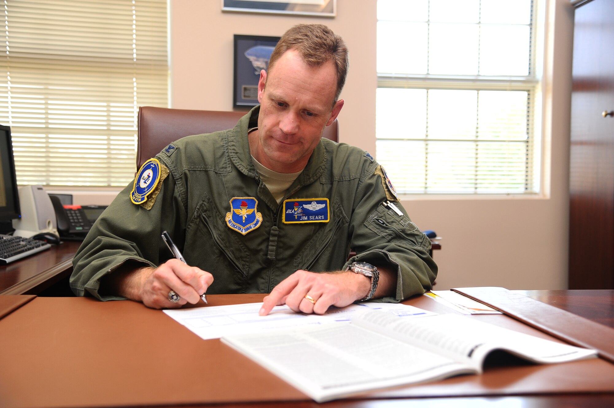 Col. Jim Sears, 14th Flying Training Wing Commander fills out a Combined Federal Campaign donation form. The Fiscal Year 2012 Combined Federal Campaign spans from Oct. 1 to Oct. 31. The CFC brings together federal employees throughout the United States and abroad to take part in the largest and most successful workplace charity campaign in the United States. (U.S. Air Force photo/Senior Airman Chase Hedrick)