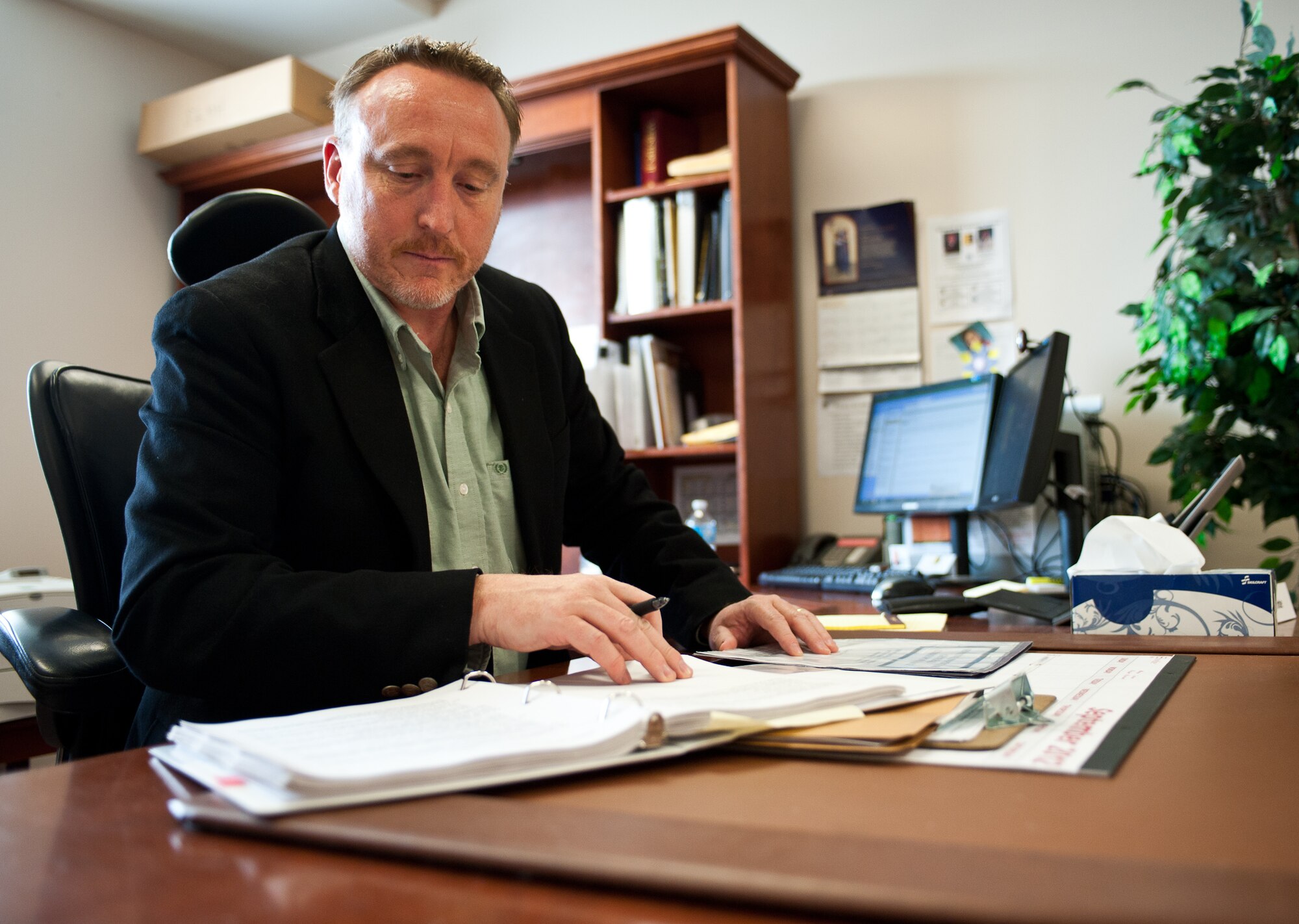 Mark Schlichte, 28th Bomb Wing inspector general, references Air Force instructions related to a case at Ellsworth Air Force Base, S.D., Sept. 27, 2012. The mission of the IG is to ensure all Airmen have uninhibited access to report wrongdoings without the fear of reprisal, to manage Congressional inquiries, and the base’s Fraud, Waste, and Abuse program. (U.S. Air Force photo by Airman 1st Class Alystria Maurer/Released)