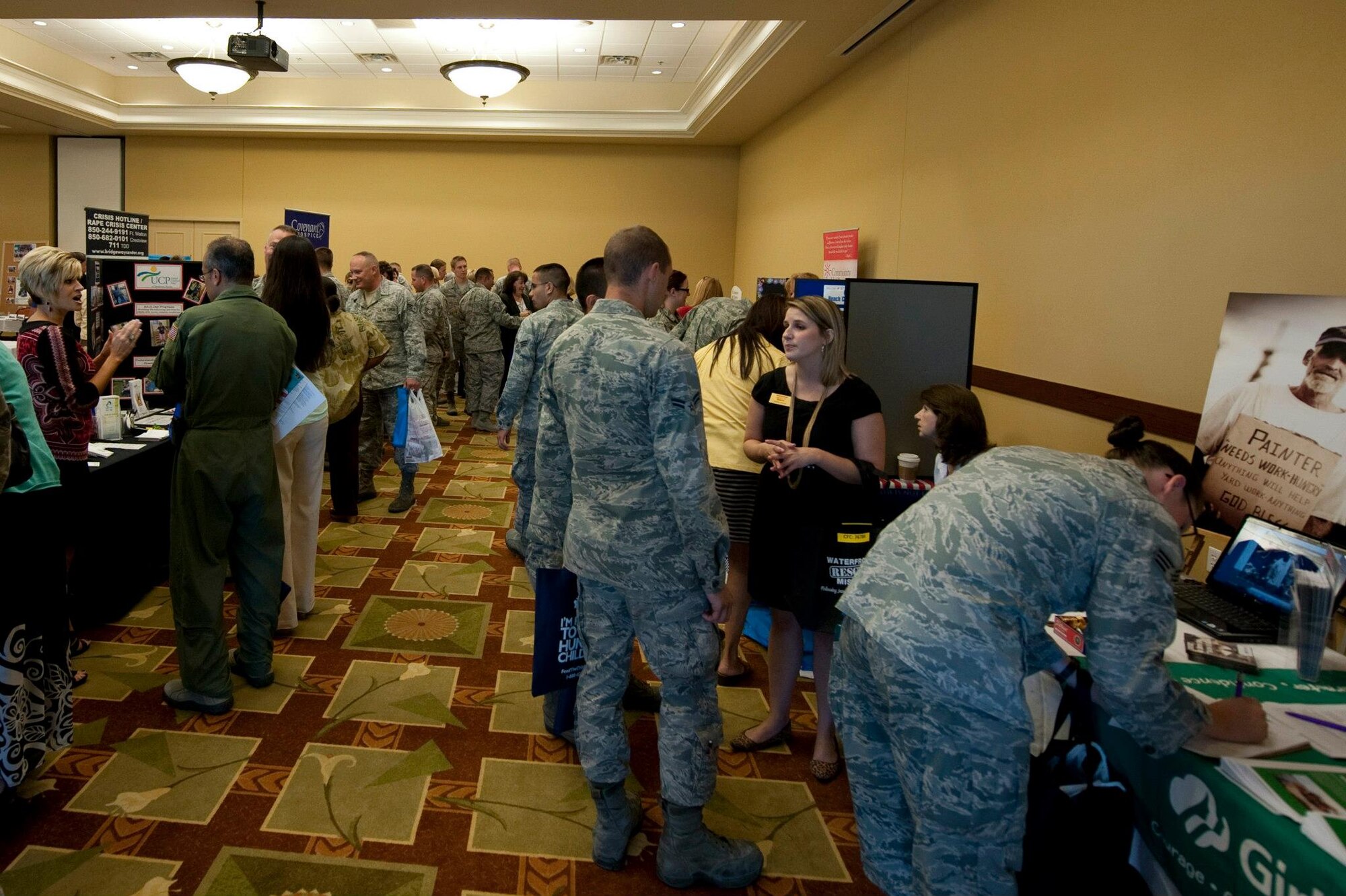 Airmen visit various booths for information during the Combined Federal Campaign kickoff at the Soundside Club at Hurlburt Field, Fla., Sept. 25, 2012. Organizations with different causes presented an abundance of information for Airmen before they potentially donate to the campaign. (U.S. Air Force Photo/Airman 1st Class Benjamin D. Kim)