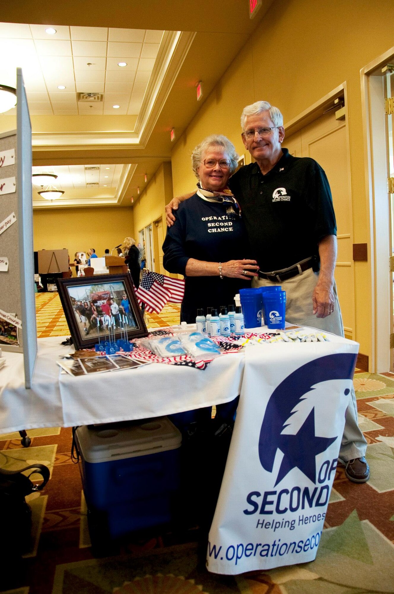 Molly and Bob Larson, representatives of an organization that supports veterans, pose at their booth during the Combined Federal Campaign kickoff at the Soundside Club at Hurlburt Field, Fla., Sept. 25, 2012. Many booths provided complementary items to market their respective programs within the CFC. (U.S. Air Force Photo/Airman 1st Class Benjamin D. Kim)