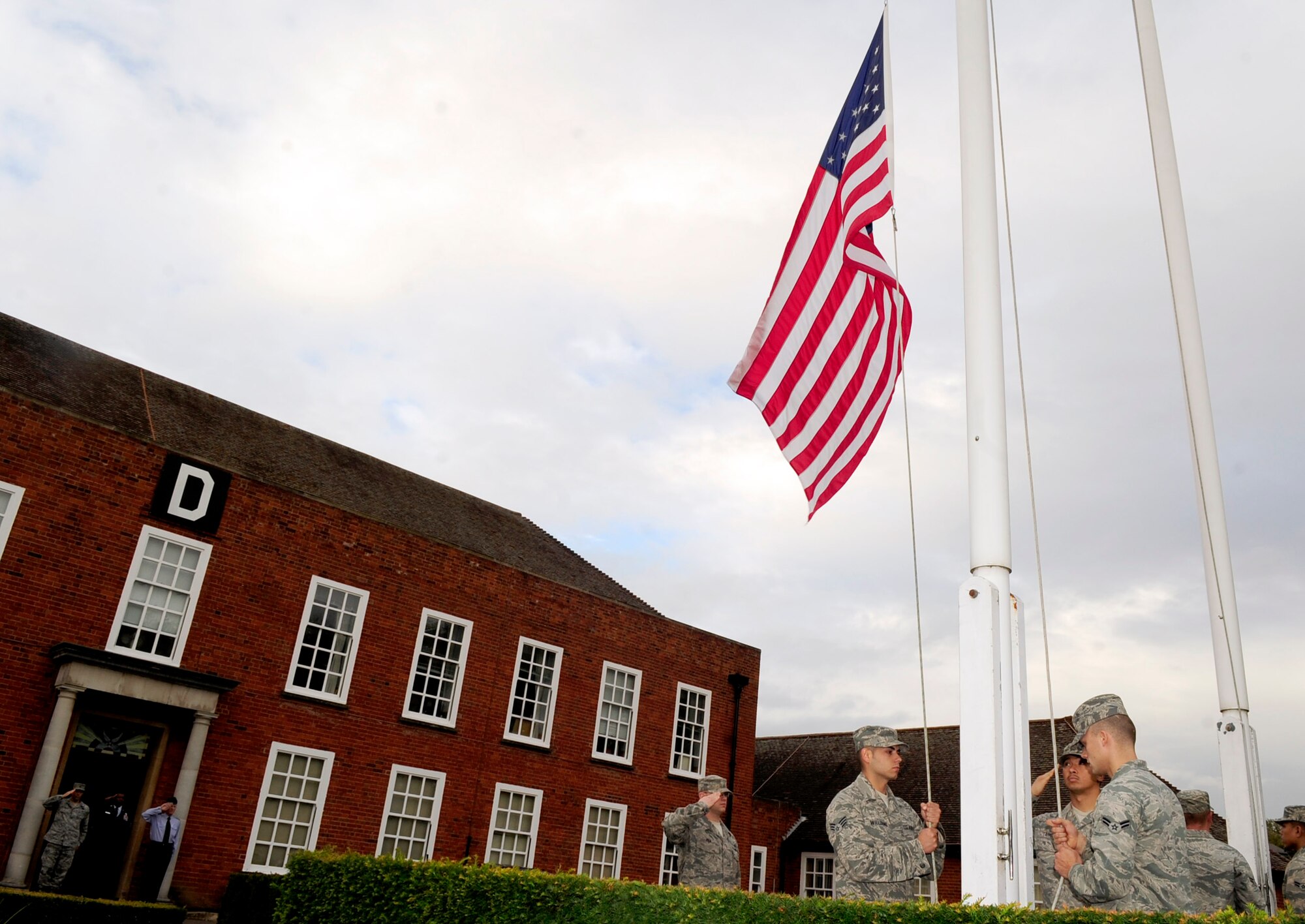 RAF MILDENHALL, England – Airmen from the 100th Maintenance Group lowers the American flag during a retreat ceremony Sept. 28, 2012, at RAF Mildenhall. Retreat signals the end of the duty day while also paying respect to the American flag. (U.S. Air Force photo/Senior Airman Ethan Morgan)