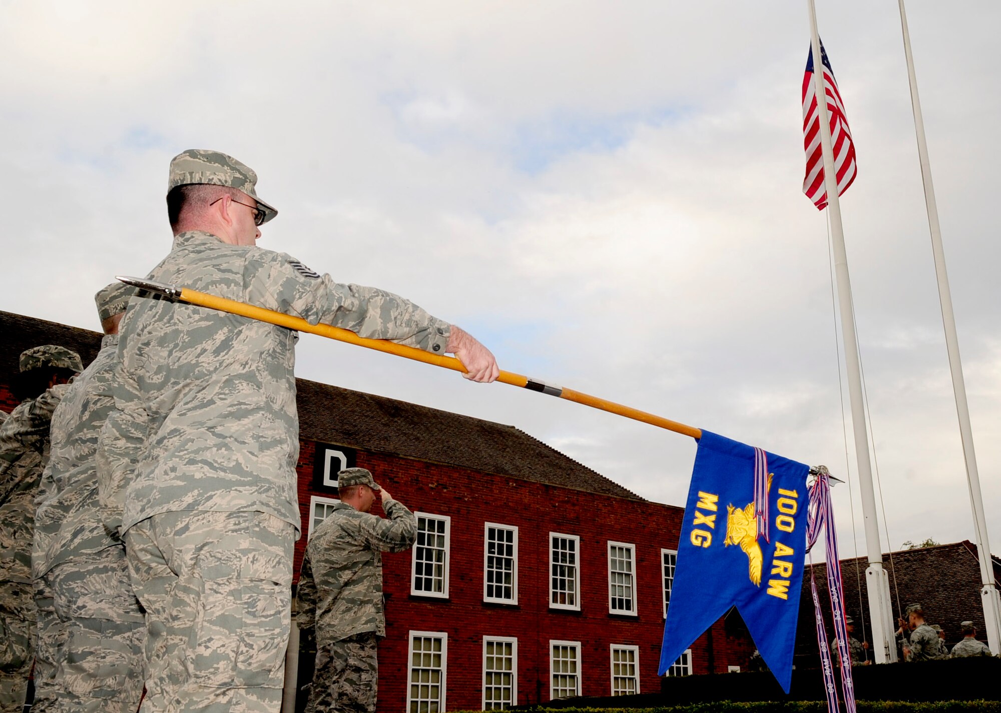 RAF MILDENHALL, England -- Airmen from the 100th Maintenance Group salute the American flag and Royal Air Force Ensign during a retreat ceremony Sept. 28, 2012, at RAF Mildenhall. The monthly ceremony was hosted by the 100th MXG and signals the end of the duty day. (U.S. Air Force photo/Senior Airman Ethan Morgan)