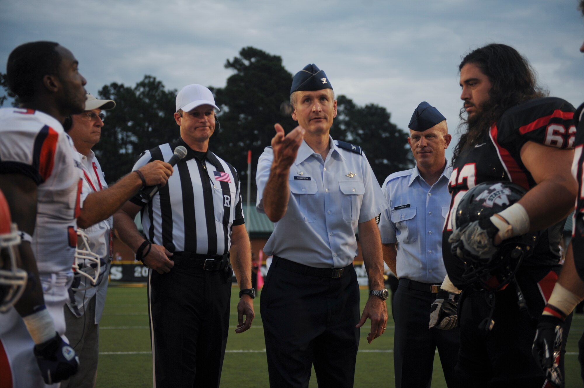 U.S. Air Force Col. Billy Thompson, 23d Wing commander, performs a coin toss during a football game at the Bazemore-Hyder Stadium in Valdosta, Ga., Sept. 29, 2012. The Valdosta State University Blazers won the coin toss and elected to receive the ball for the initial kickoff. (U.S. Air Force photo by Airman 1st Class Olivia Dominique/Released)