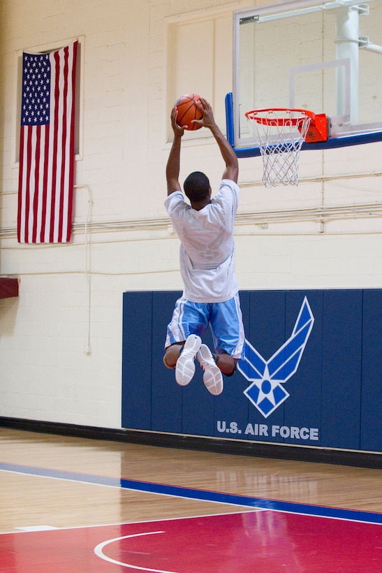 A Sporks Week participant goes up for the dunk while warming up for the three-on-three basketball tournament. (Photo by Matthew Jurgens)