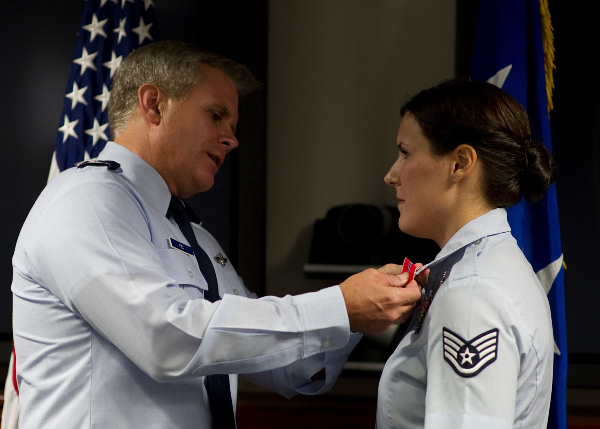 Lt. Gen. Eric Fiel, Air Force Special Operations Command commander, pins a Bronze Star on Staff Sgt. Jamie Fremgen, 11th Intelligence Squadron analyst, Sept. 24 at Hurlburt Field, Fla. Fremgen was the first enlisted Airman to deploy as a Cultural Support Team leader. Her mission was to engage Afghanistan’s female and adolescent population when interaction with male service members could be deemed culturally inappropriate. (U.S. Air Force photo by Airman 1st Class Christopher Williams)