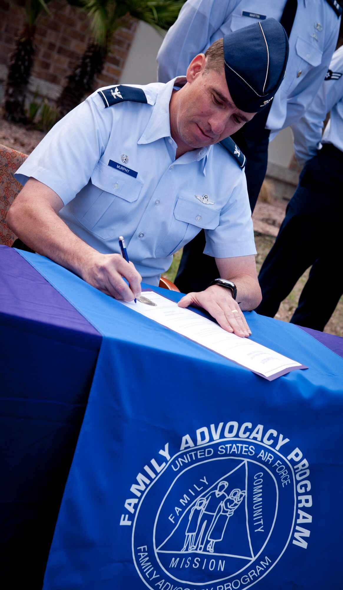 Col. Tom Murphy, 47th Flying Training Wing commander, signs a proclamation declaring October as Domestic Violence Awareness Month at Laughlin’s medical clinic Oct.3, 2012. The designation is meant to bring to light the crime of domestic violence and its violation of an individual’s privacy and dignity, security and humanity. (U.S. Air Force photo/Airman 1st Class Nathan Maysonet)