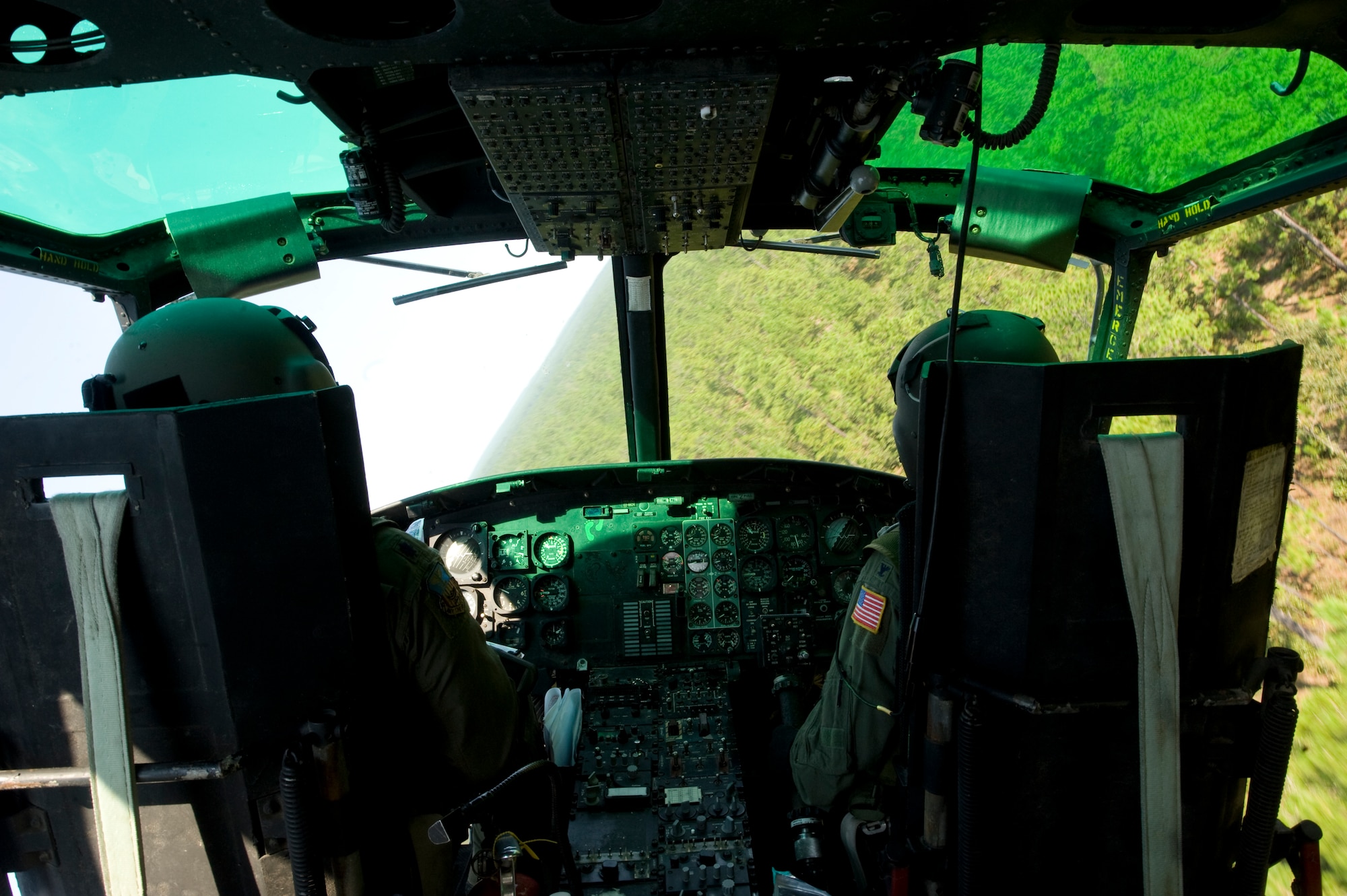 U.S. Air Force Col. Jim Slife, commander of 1st Special Operations Wing, left, and Lt. Col. Thomas Lang, assistant to 1st SOW vice wing commander, right, make a dynamic turn over a forest in southern Alabama Sept. 19, 2012.  The UH-1N’s primary mission includes airlift of emergency security and disaster response forces, support for school training and testing, and airlift for distinguished visitors and missile support people, according to the aircraft’s factsheet on the Air Force website. (U.S. Air Force photo/ Airman First Class Nigel Sandridge)