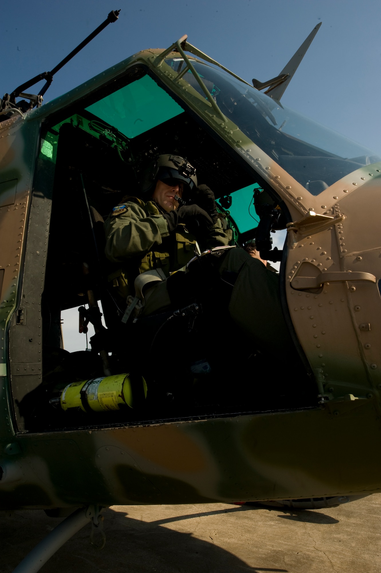 U.S. Air Force Col. Jim Slife, commander of 1st Special Operations Wing, prepares his flight equipment before takeoff in a UH-1N helicopter at an air field in southern Alabama Sept. 19, 2012. Slife made sure all equipment properly functioned before the aircraft’s departure.  (U.S. Air Force photo/ Airman First Class Nigel Sandridge)