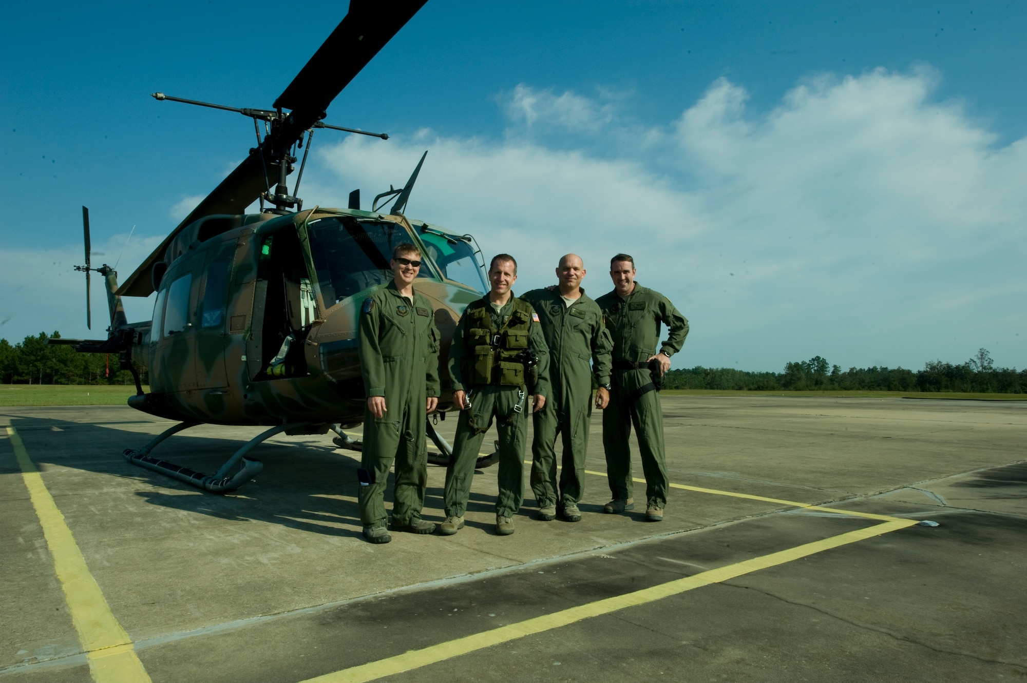 (From left to right) U.S. Air Force Tech. Sgt. Mark Schroeder, flight scheduling NCO of 6th Special Operations Squadron, Col. Jim Slife, commander of 1st Special Operations Wing, Lt. Col. Thomas Lang, assistant to 1st SOW vice wing commander, and Senior Master Sgt. Clint Grizzell, superintendent of 6th SOS, stand in front of a UH-1N helicopter on an air field in southern Alabama Sept. 19, 2012. The crew took part in the final flight of the UH-1N helicopter from Hurlburt Field. (U.S. Air Force photo/ Airman First Class Nigel Sandridge)