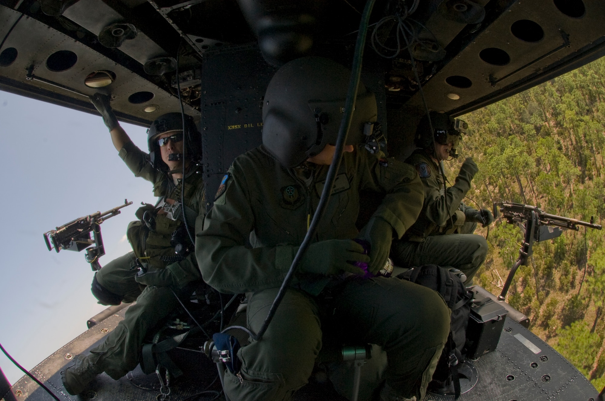 The aircrew of a UH-1N prepares for a sharp tactical maneuver over a forest in southern Alabama Sept. 19, 2012. The UH-1N belonged to 6th Special Operations Squadron. (U.S. Air Force photo/ Airman First Class Nigel Sandridge)