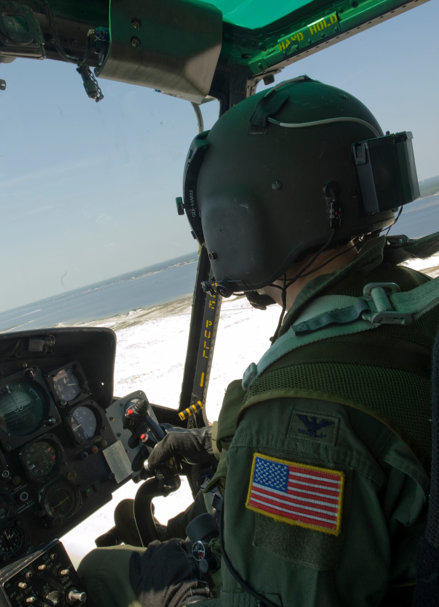U.S. Air Force Col. Jim Slife, commander of 1st Special Operations Wing, flies a UH-1N helicopter over a beach in Navarre, Fla., Sept. 19, 2012. As base commander and an MH-53 helicopter pilot himself, Slife had the honor of piloting the last Huey flight from Hurlburt Field. (U.S. Air Force photo/ Airman First Class Nigel Sandridge)