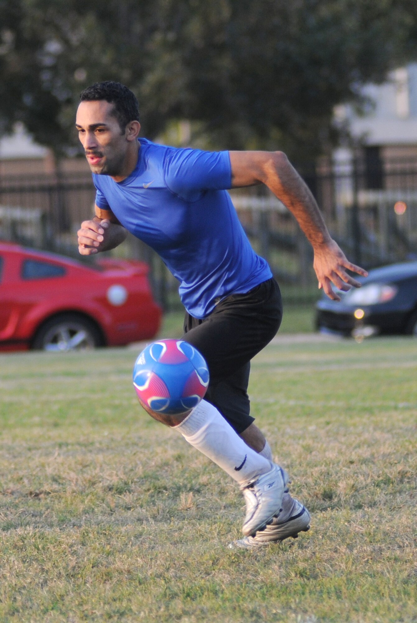 Anthony Bustamante, 333rd Training Squadron, dribbles the ball down the field during the intramural soccer championship Sept. 25, 2012, at Keesler Air Force Base, Miss.  The Gators defeated the Spartans 5-3.  (U.S. Air Force photo by Kemberly Groue)