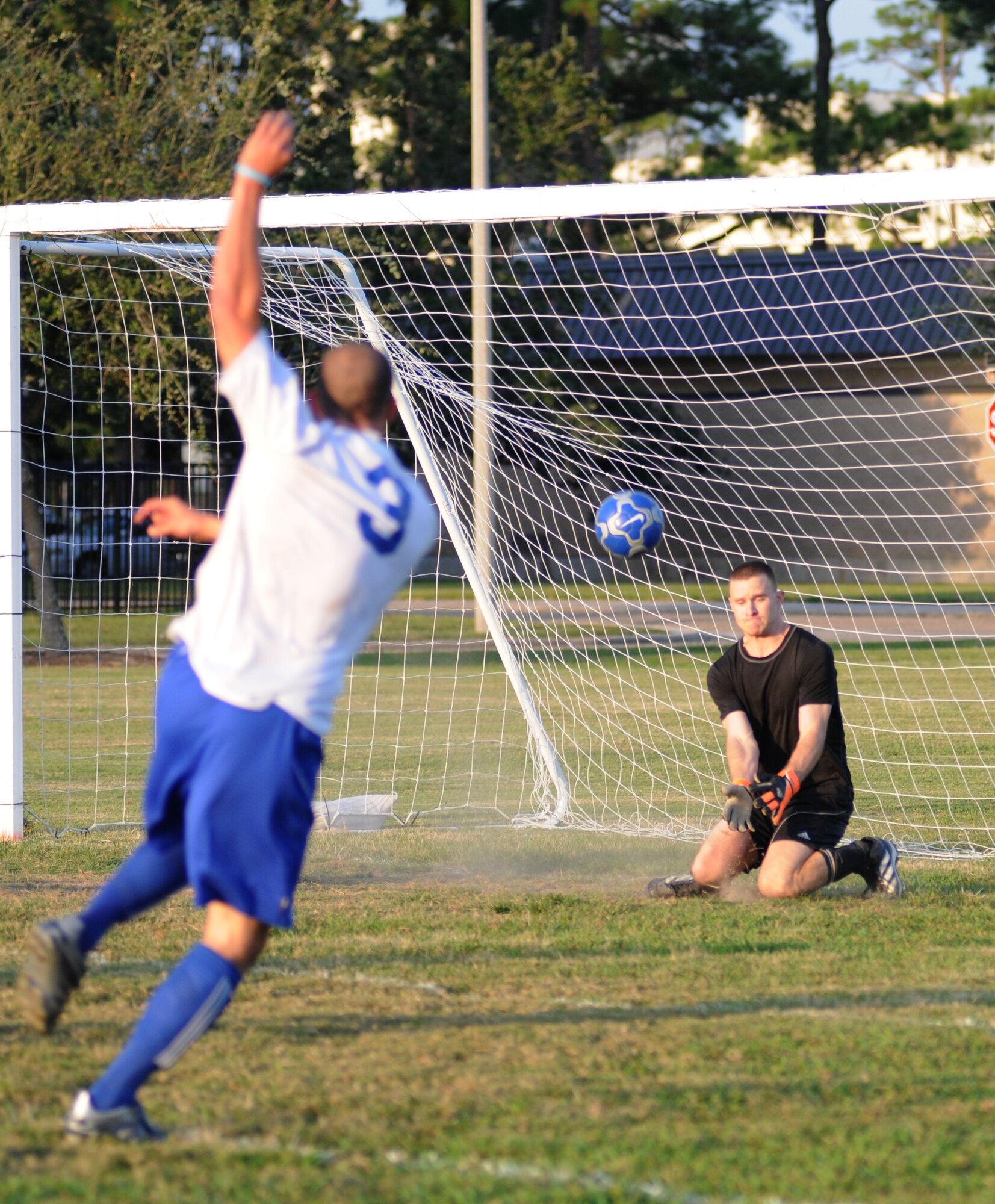Steve Bordelon, 334th Training Squadron, shoots the ball to the goal as Michael Vetri, 333rd Training Squadron, gets in position for a block during the intramural soccer championship Sept. 25, 2012, at Keesler Air Force Base, Miss.  The Gators defeated the Spartans 5-3.  (U.S. Air Force photo by Kemberly Groue)