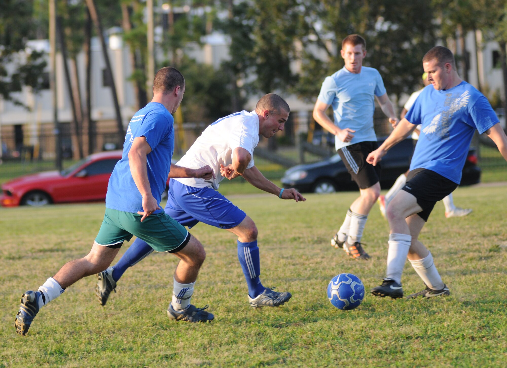 Steve Bordelon, 334th Training Squadron (in white) moves the ball down the field as Matthew Neeld, Daniel Votipka, and Brian Gendreau, 333rd Training Squadron, hustle toward the ball during the intramural soccer championship Sept. 25, 2012, at Keesler Air Force Base, Miss.  The Gators defeated the Spartans 5-3.  (U.S. Air Force photo by Kemberly Groue)