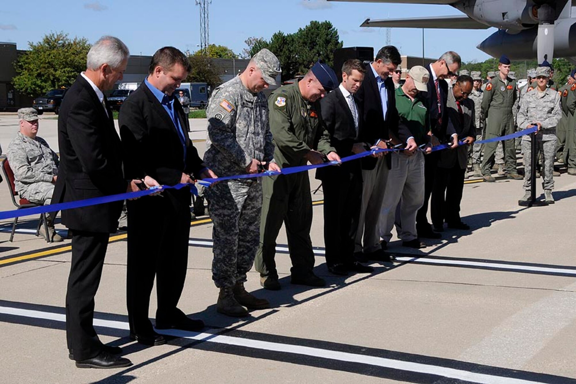 Brigadier General Johnny R. Miller, Assistant Adjutant General - Army, Illinois National Guard and Colonel William P. Robertson, Commander, 182nd Airlift Wing, cut the ceremonial ribbon for an outdoor ceremony celebrating the opening of the new Squadron Operations Facility held Saturday, September 8 with local elected officials and representatives of contractors involved with the building’s construction at the 182nd Airlift Wing in Peoria, Ill. (U.S. Air Force photo by Tech. Sgt. Todd Pendleton/Released.)  