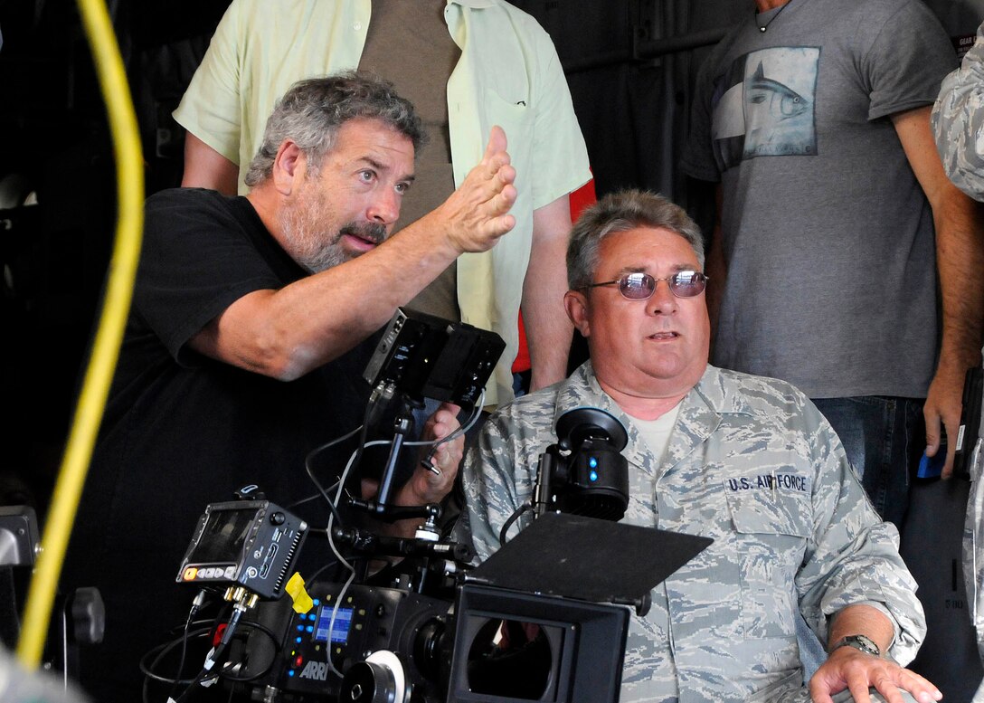 Mr. Lewis Roth (left), a film director with Boom Town Productions, discusses how he would like to document a scene with Senior Master Sgt. David Snook, an Aerospace Maintenance Superintendent with the 182nd Airlift Wing, in the cargo compartment of a C-130H3 Hercules Sep. 27, 2012 in Peoria, Ill. The filming of a commercial aimed at recruiting people into the maintenance career field involves four different Air National Guard aircraft, and took three days to accomplish. (U.S. Air Force photo by Tech. Sgt. Todd Pendleton (RELEASED))