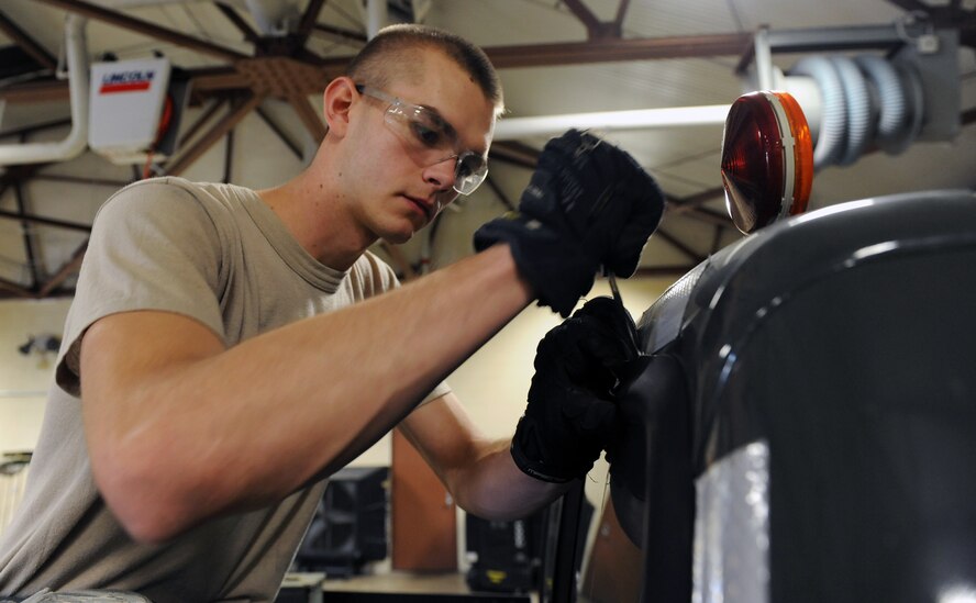 Airman 1st Class Kenneth Bates, 2nd Logistics Readiness Squadron, pries the rubber seal from the back windshield of a truck on Barksdale Air Force Base, La., Oct. 1. In order to replace or fix a windshield, the rubber seal must be removed. Along with holding the windshield in place, seals are used to prevent water damage and leaking. (U.S. Air Force photo/Senior Airman Micaiah Anthony)(RELEASED)