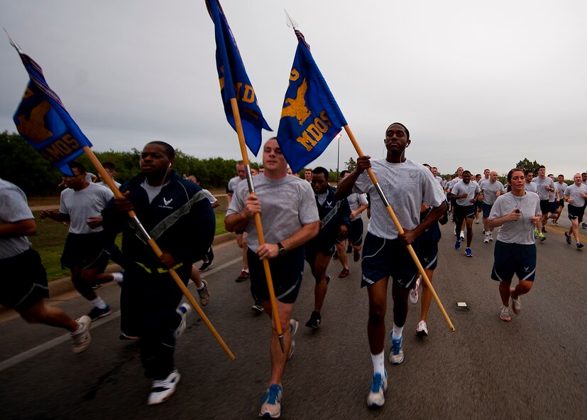 Airmen participate in a squadron run Sept. 28, 2012, as part of Comprehensive Airmen Fitness Day at Dyess Air Force Base, Texas. The day’s purpose is to strengthen understanding and application of CAF through interactive training and team-building activities. The resiliency training teaches Airmen to respond to stresses in life. There are 12 building blocks to developing resiliency. Each squadron had a resiliency training assistant who focused on teaching three of the 12 resiliency building blocks: assertive communication, hunt the good stuff and avoid thinking traps. (U.S. Air Force photo by Airman 1st Class Damon Kasberg/ Released)